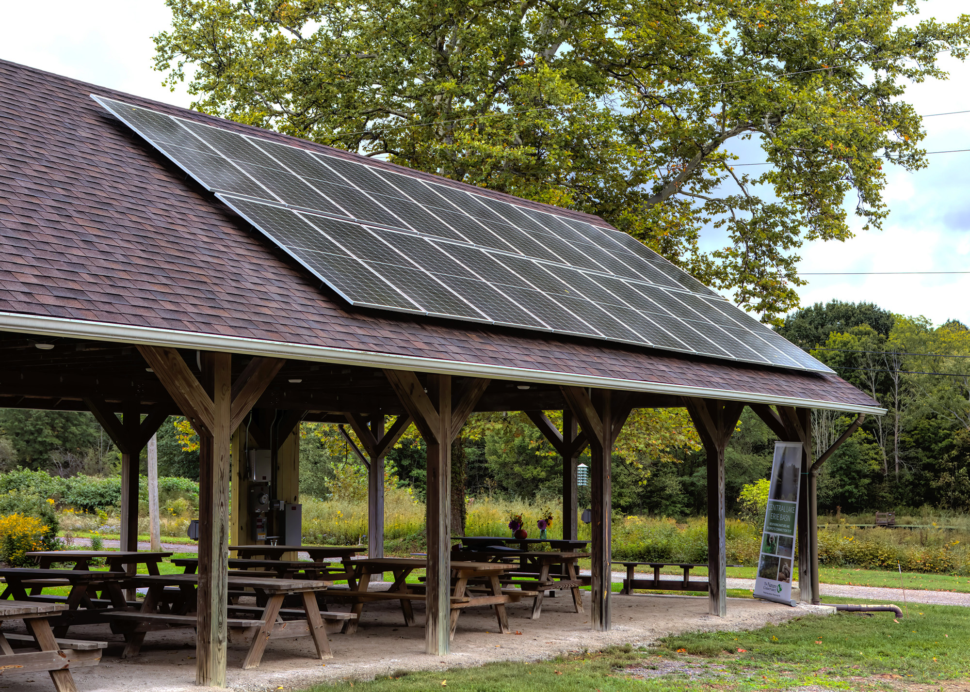 Solar panels installed on the roof of a picnic shelter.