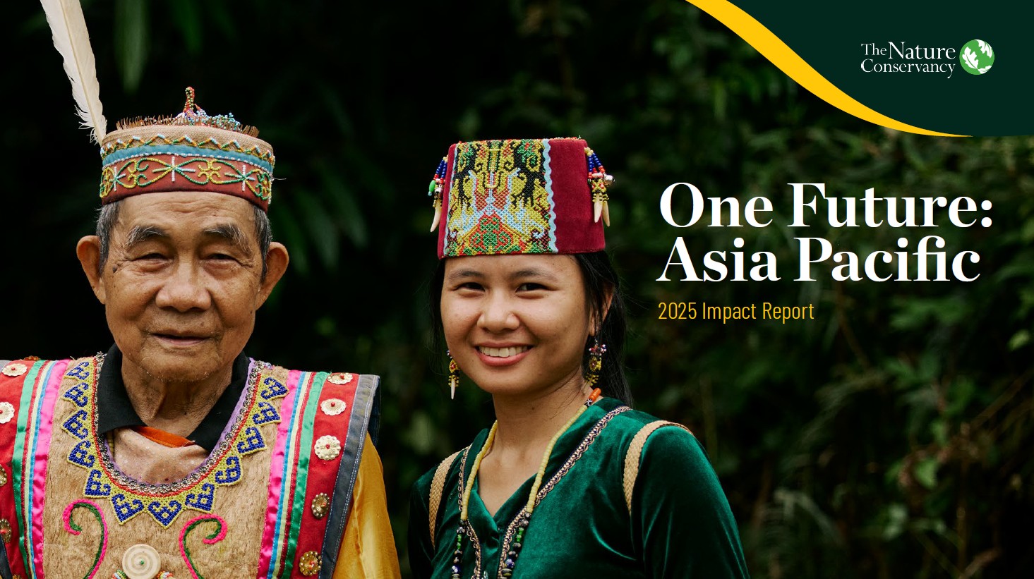 Two people in a forest smiling.