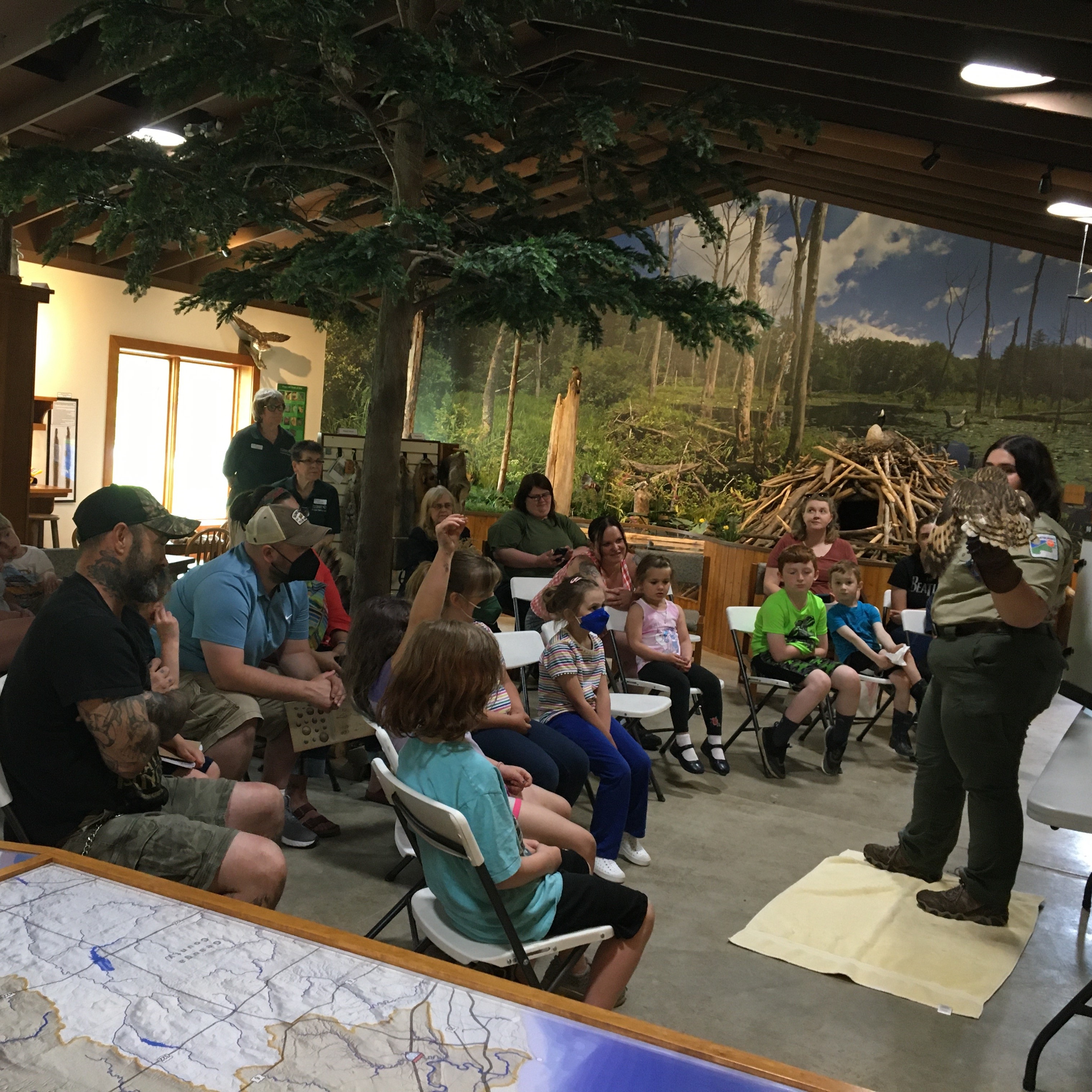 Children and adults at a program about owls.
