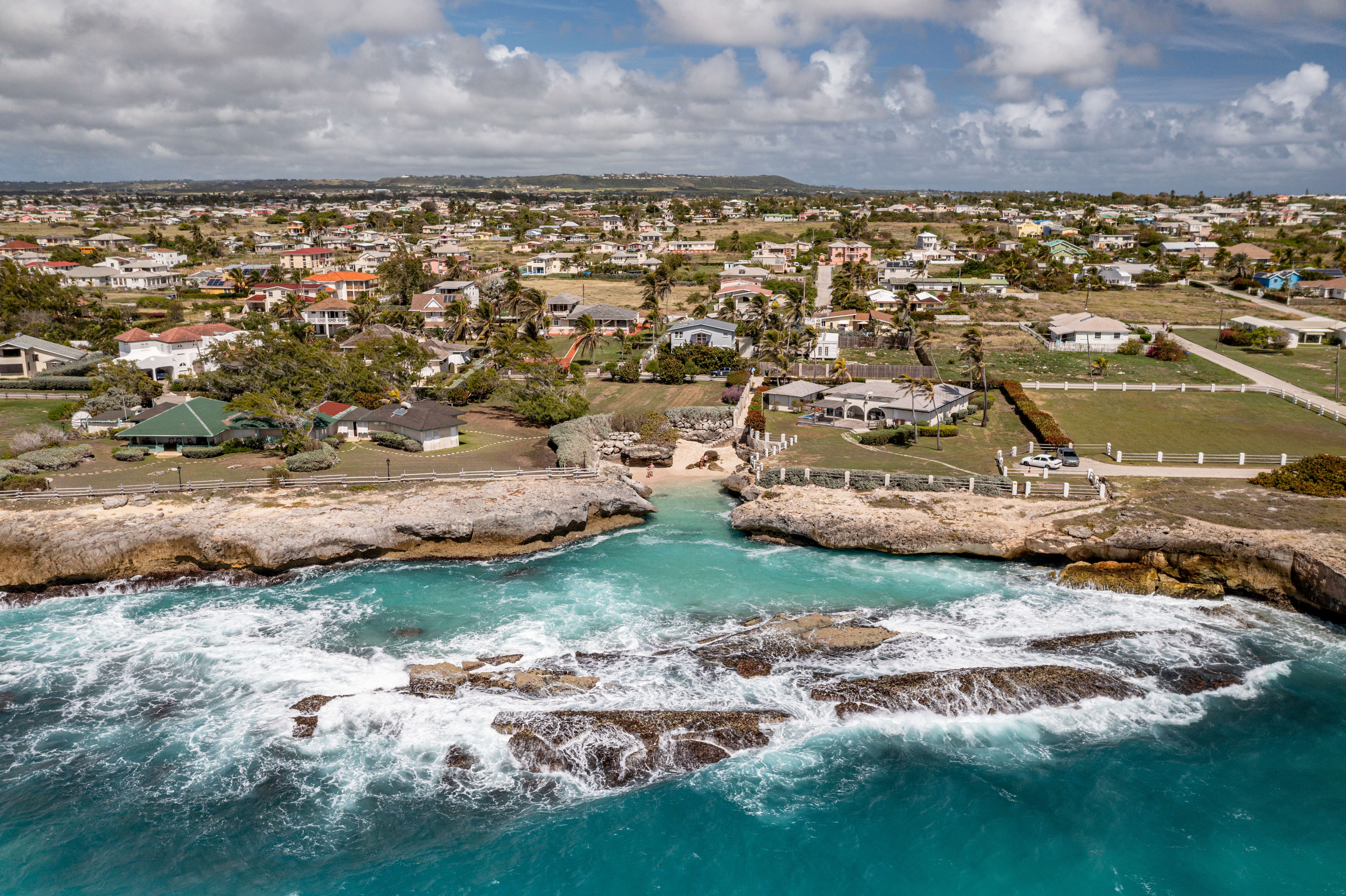 A coastal shoreline in foreground with town in back. 