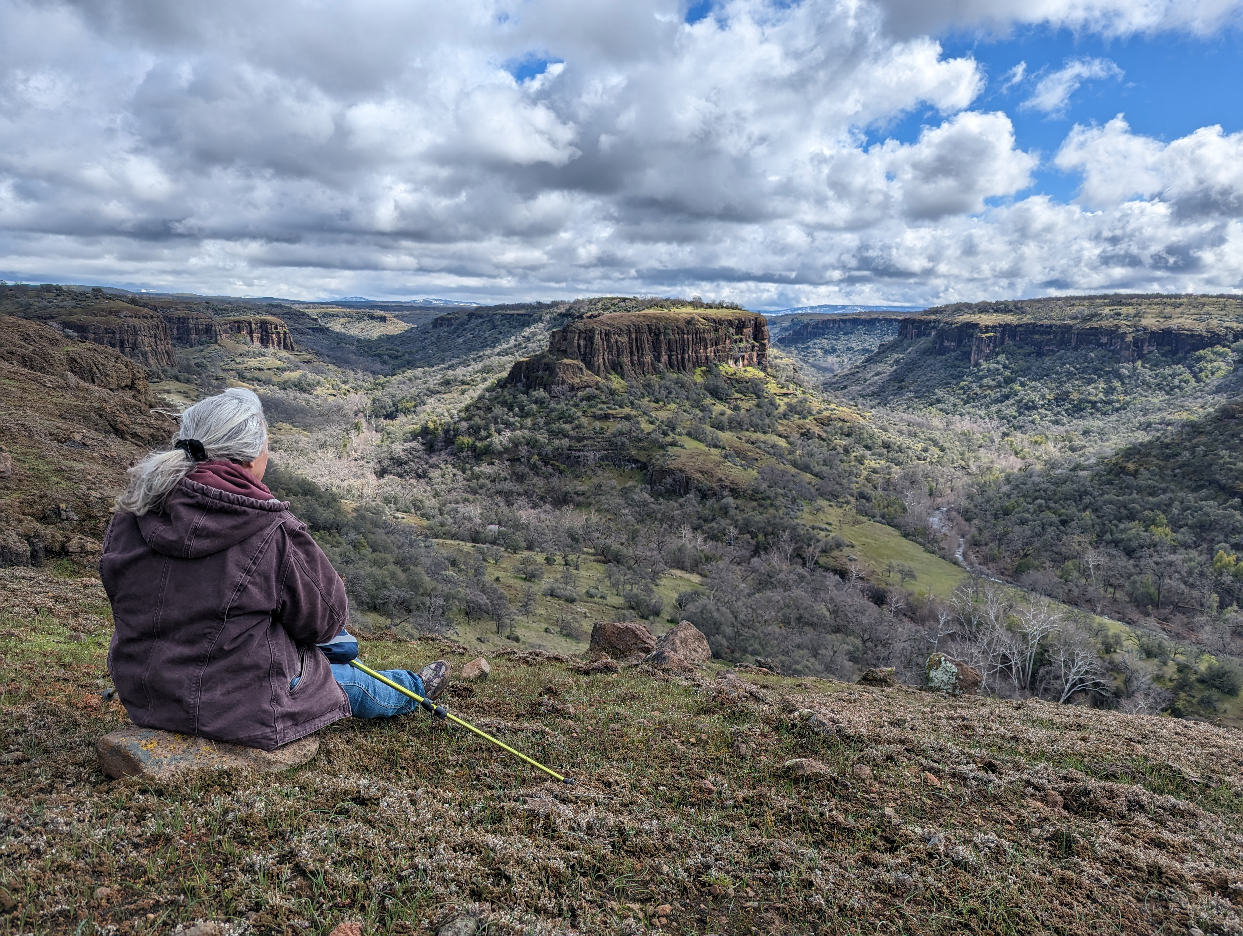 A person sitting on the edge of Dye Creek canyon.