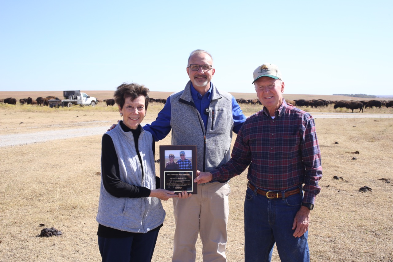 State Director Mike Fuhr presents the Conservation Champion Award to Delores and Jerry Etter.
