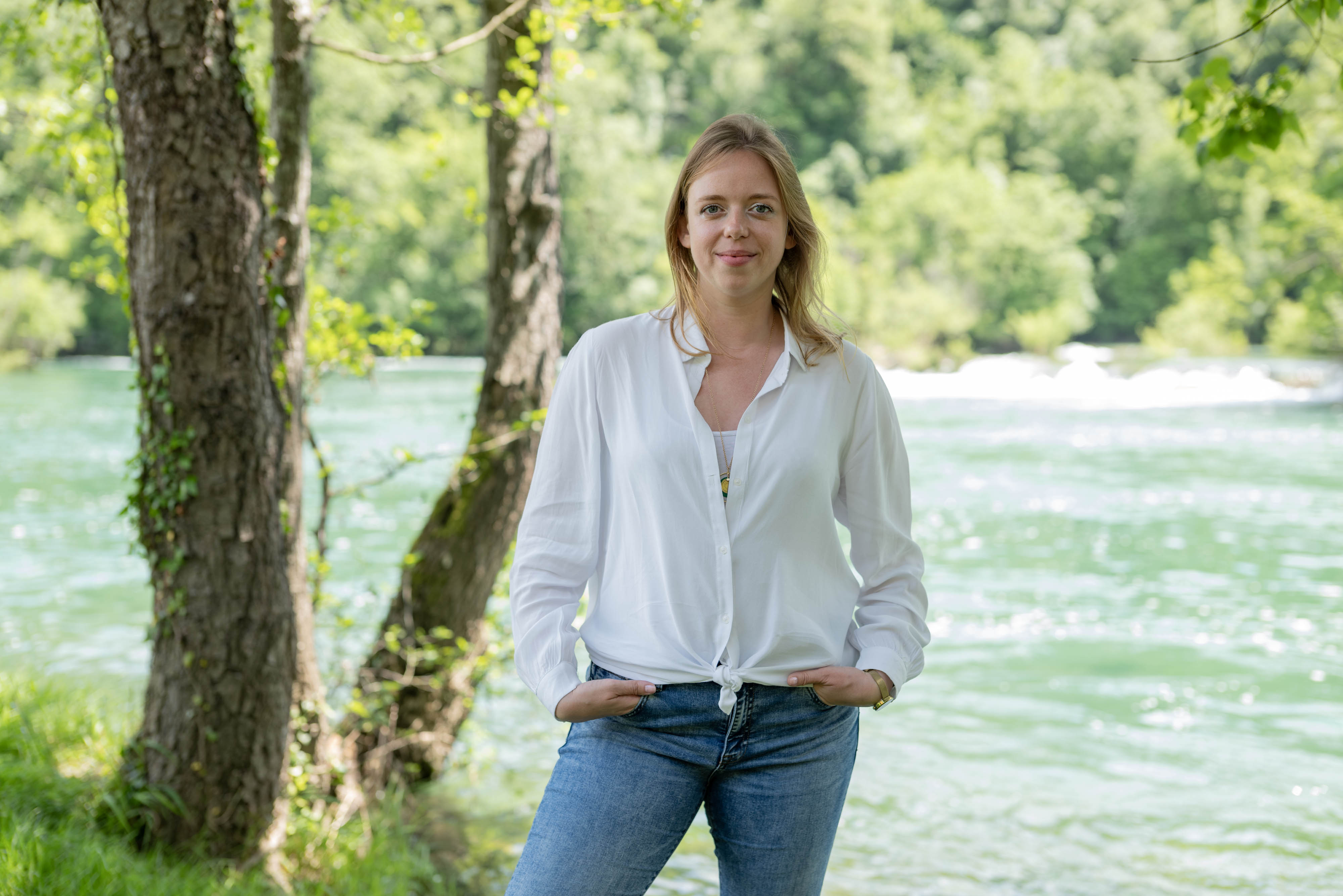 Candid portrait of Dragana Mileusnić standing next to a rushing river.