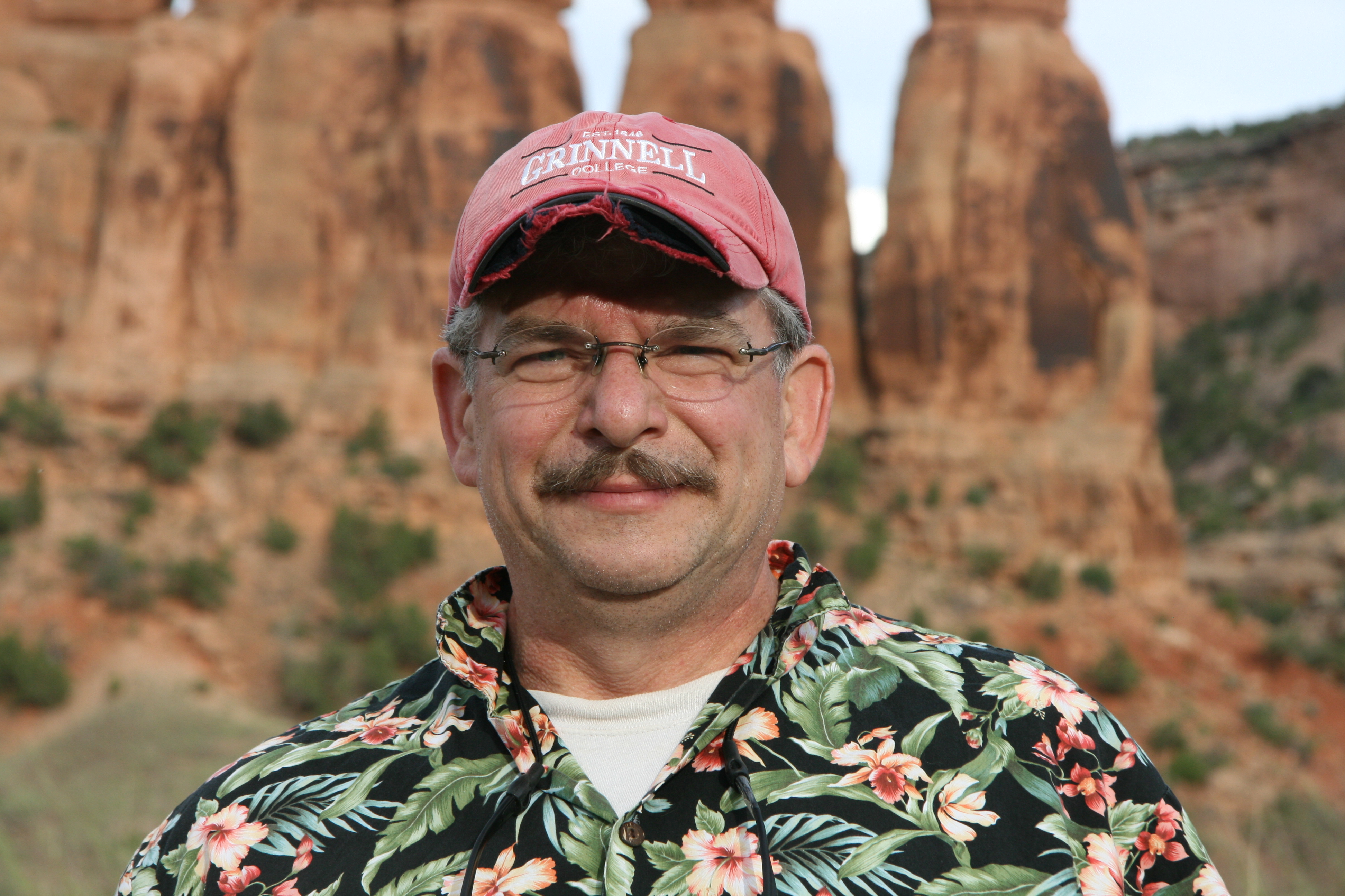 Headshot of Jonathan Higgins with red rock formations in the background.