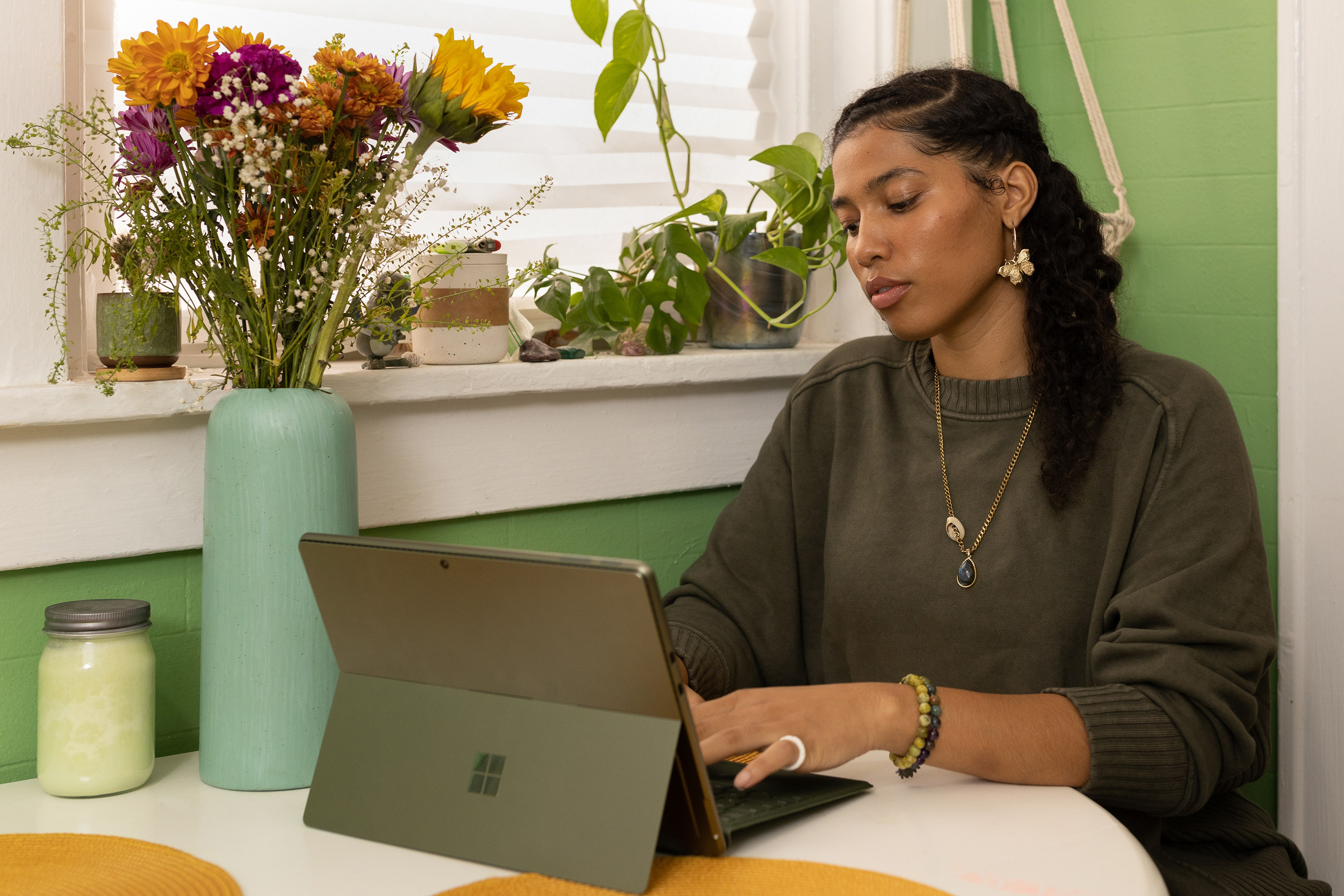 Woman works on computer in her home.