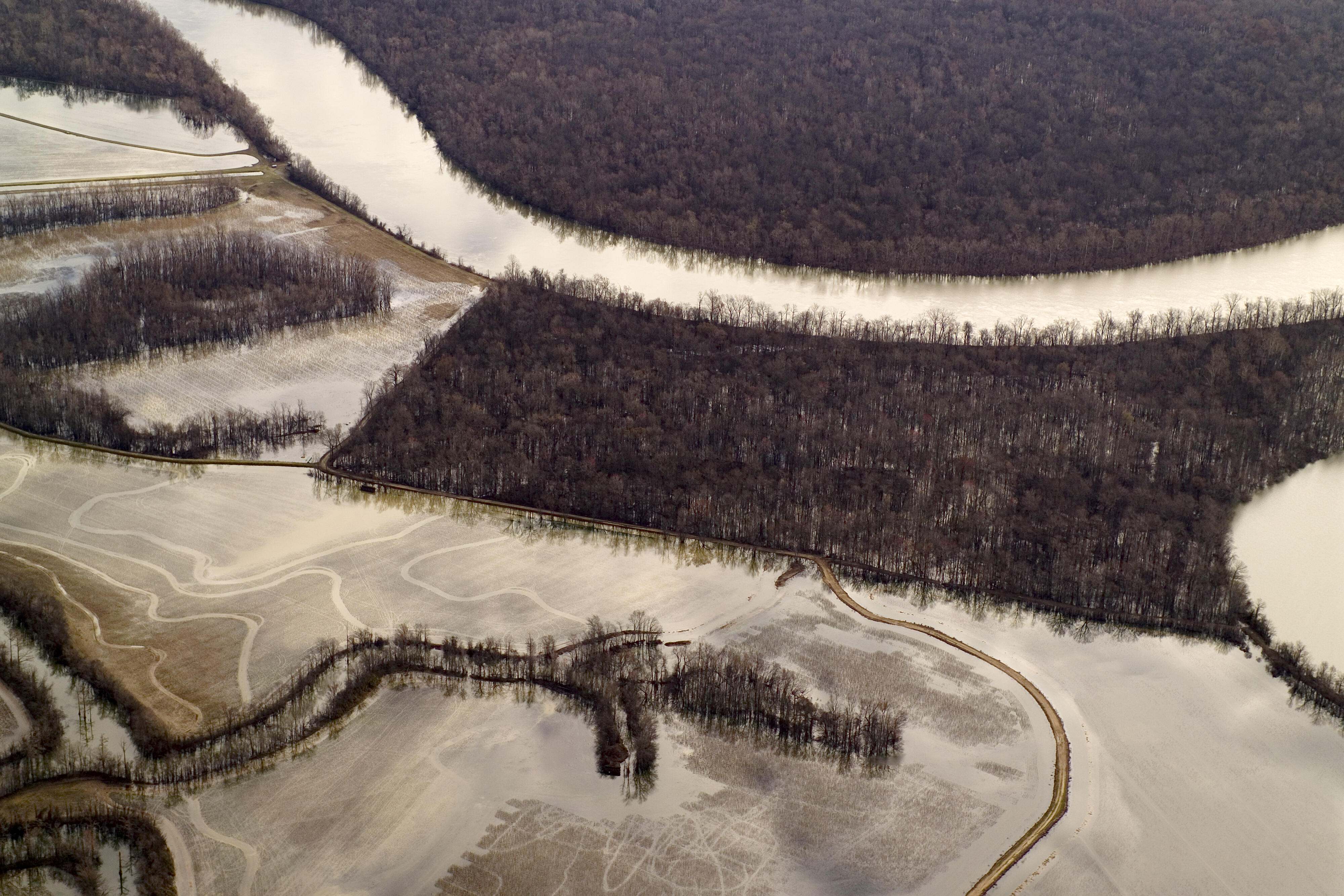 Farmland in Arkansas with a river cutting through it.