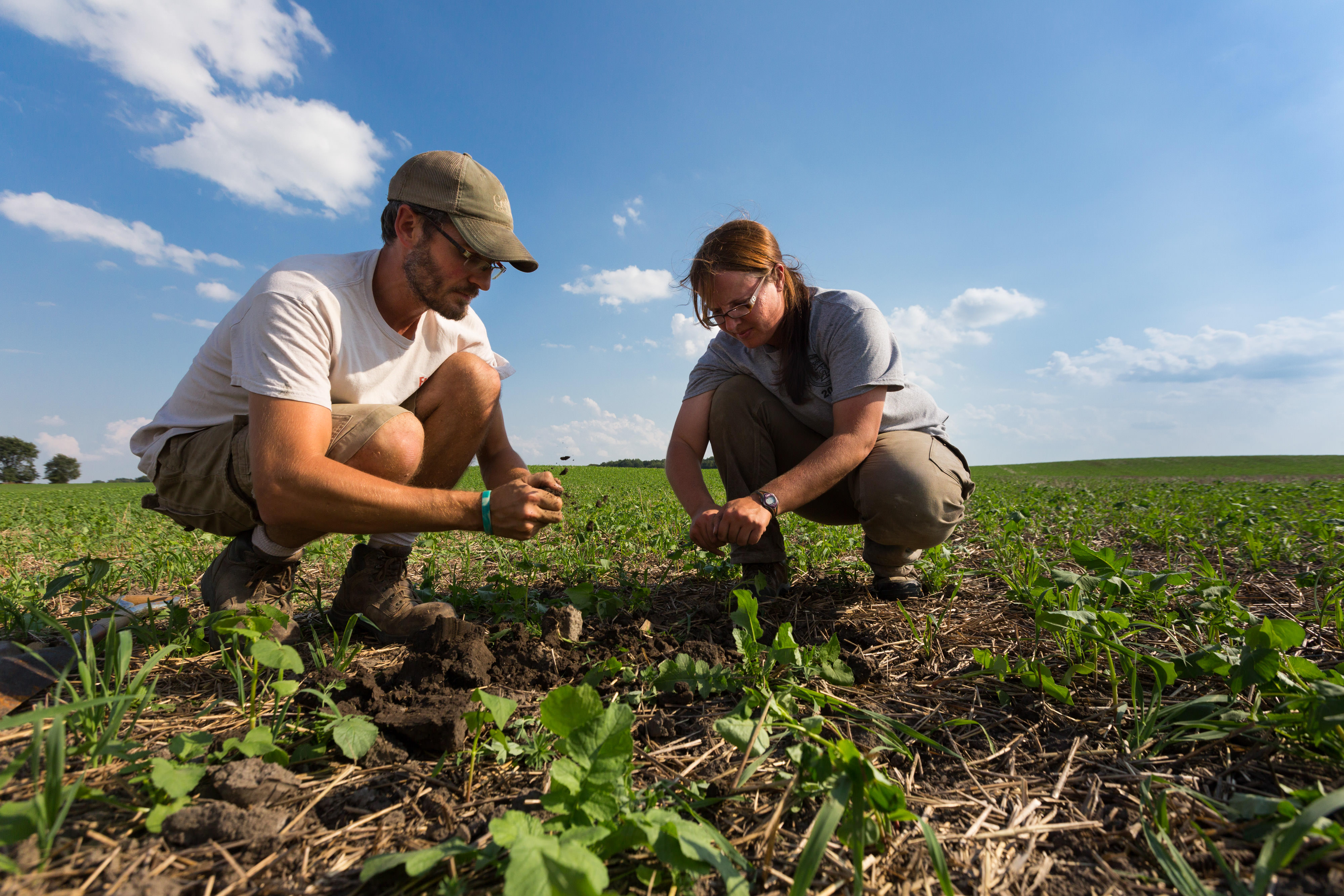 Sarah Delbecq and her husband examining their soil.