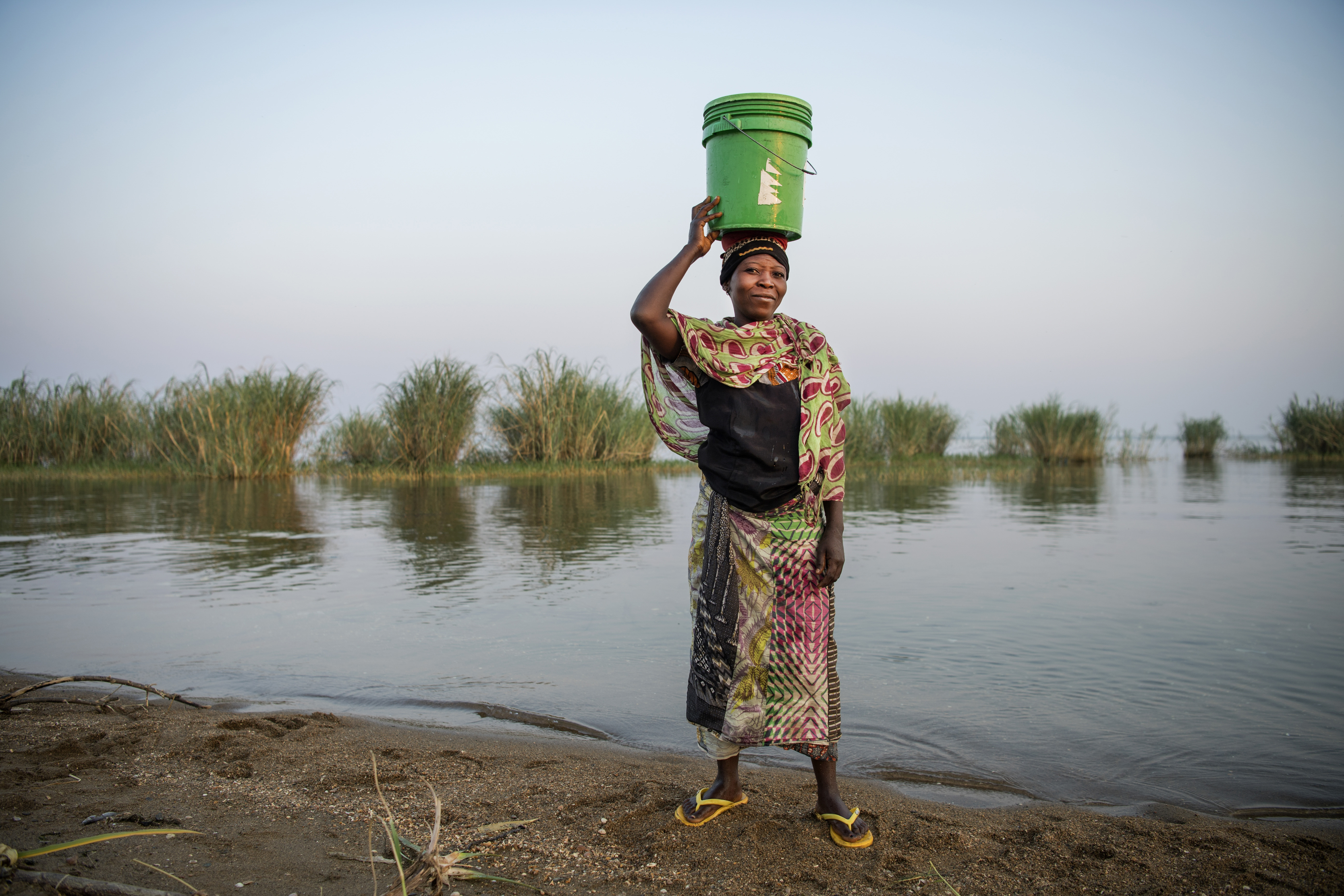 A woman gathers water from Lake Tanganyika in the village of Mgambo, Tanzania.