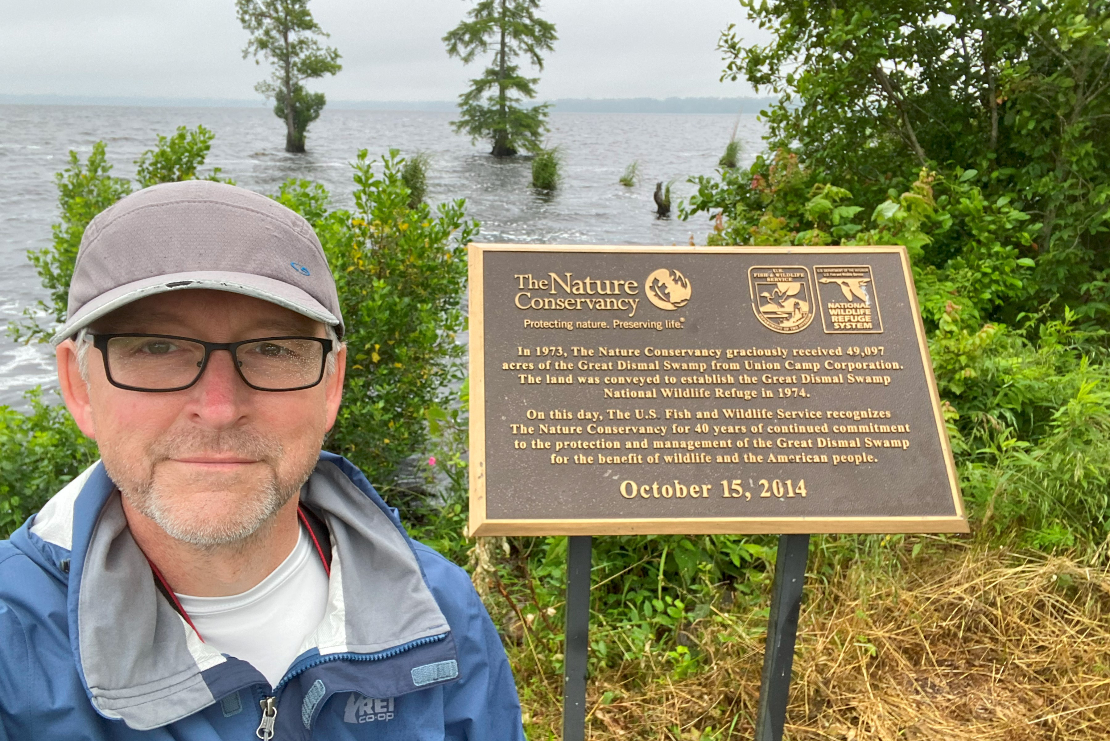 A picture of Tim Koppenhaver in front of a TNC preserve sign. 