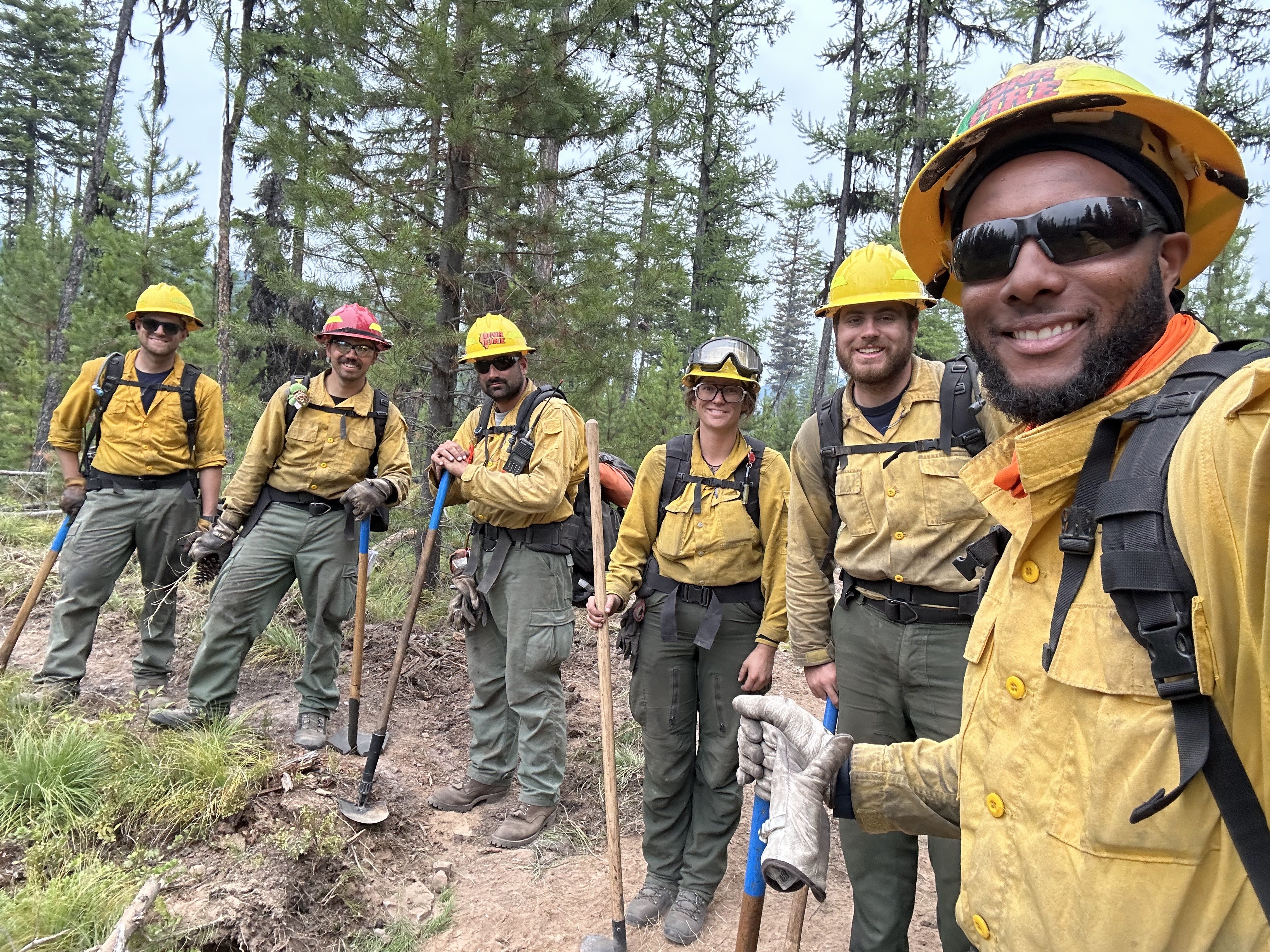 A group of burn crew members outdoors smiling.