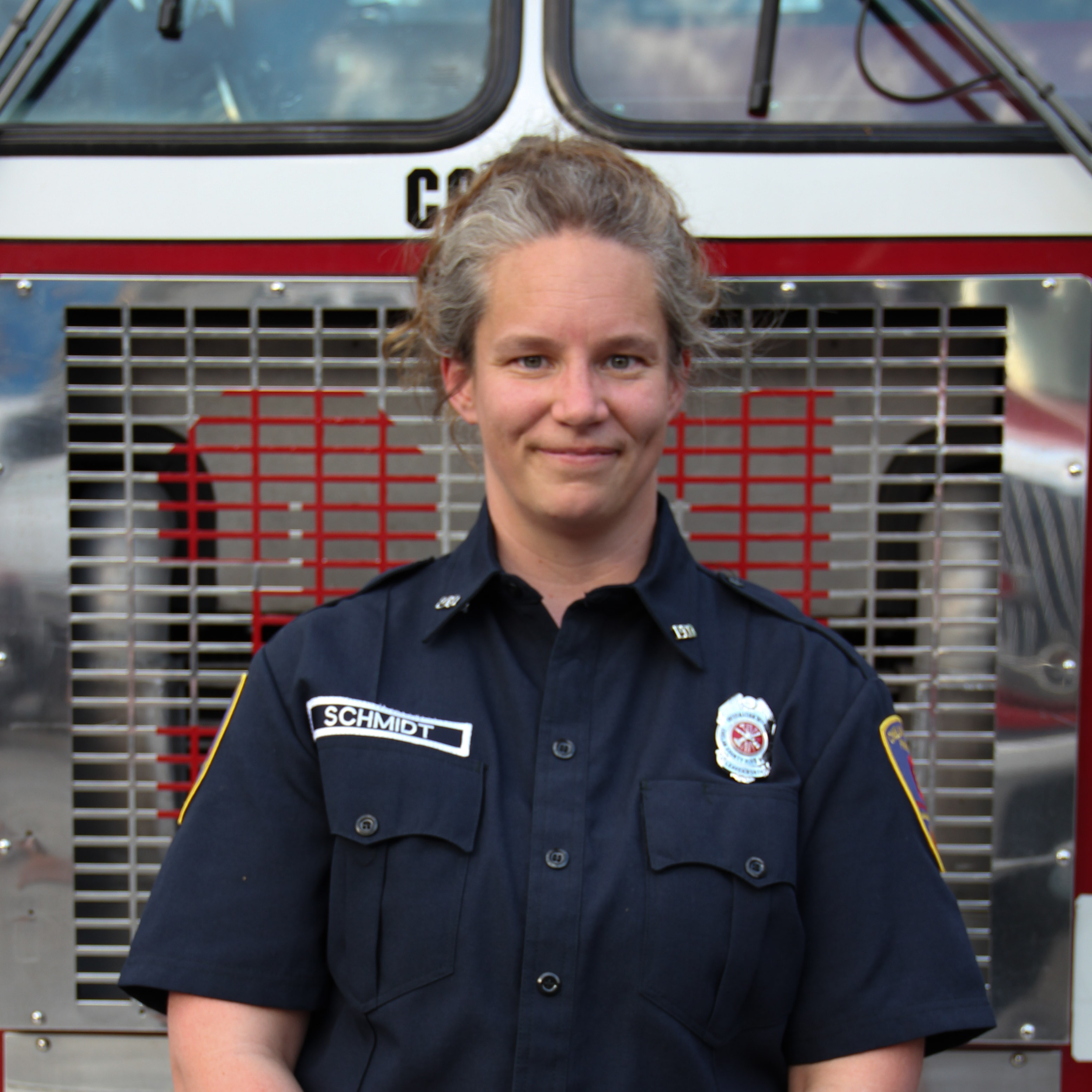 Woman in blue firefighter outfit.