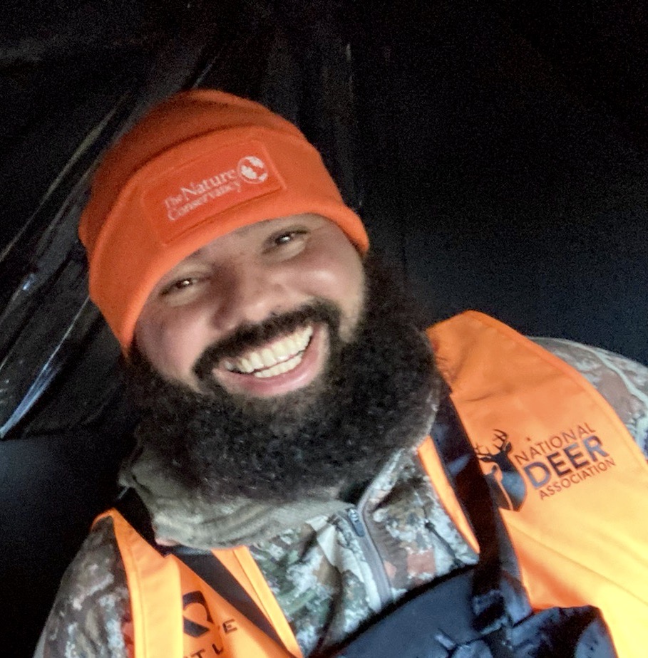 A photo of  Avery Toledo wearing a blaze orange hat.