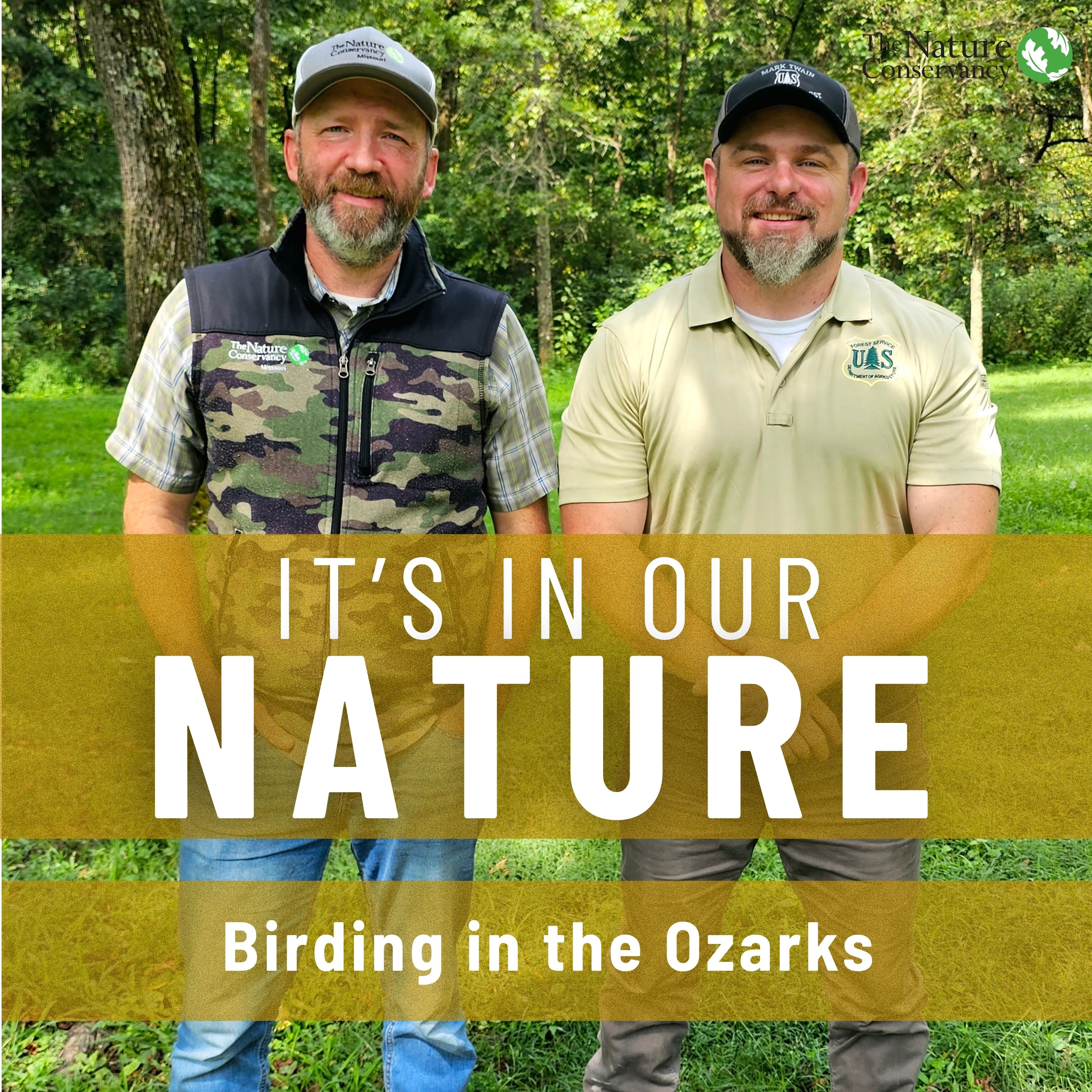 Two men posing for camera outdoors.