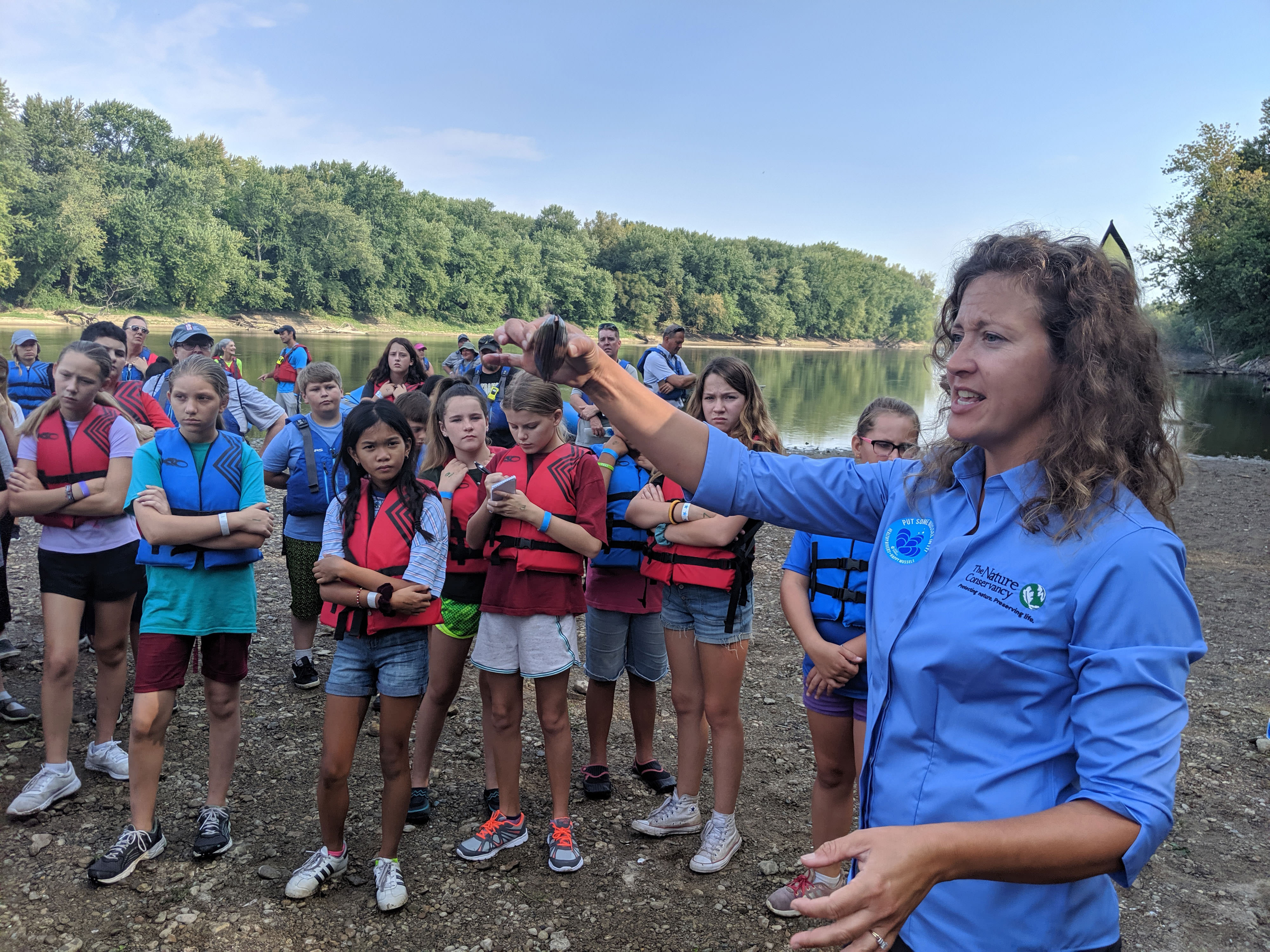 TNC staff Cassie Hauswald displays freshwater mussel.