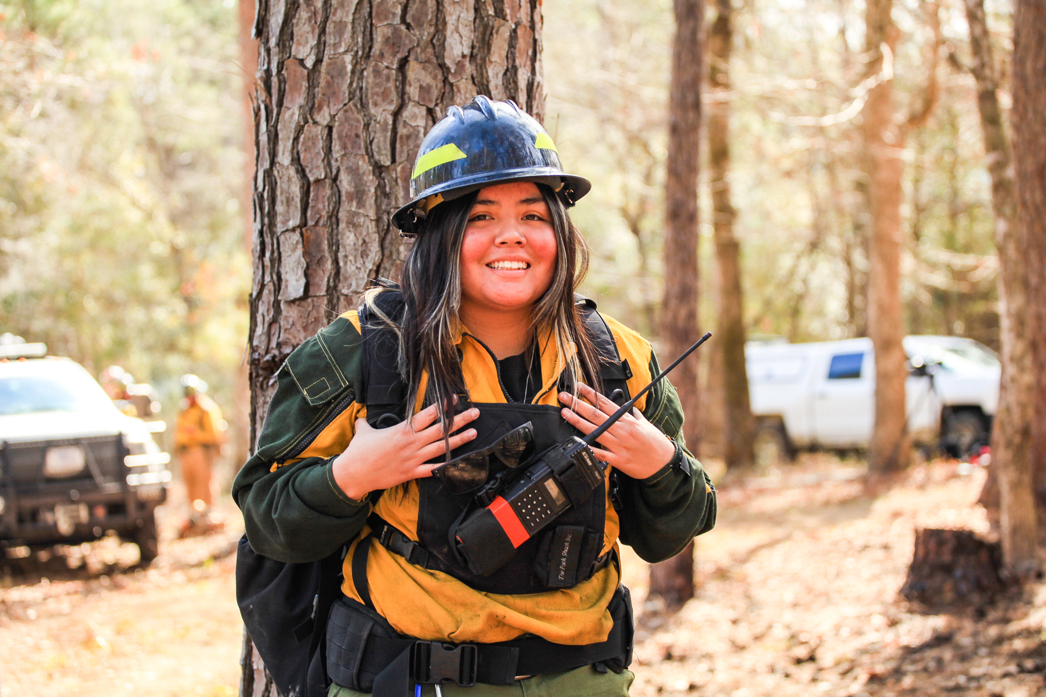 Charity Battise stands in her fire gear before a burn.