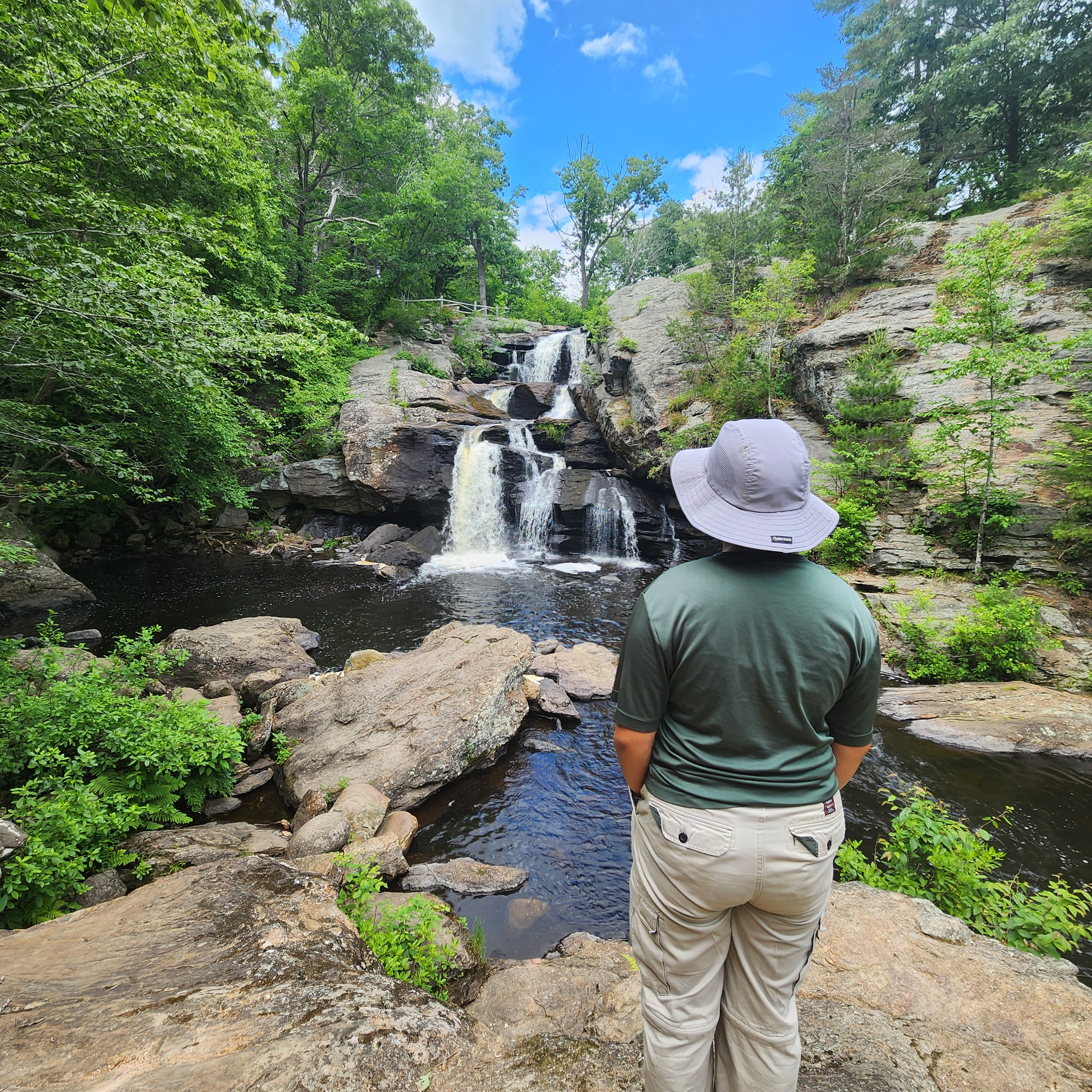 Person standing in front of a waterfell
