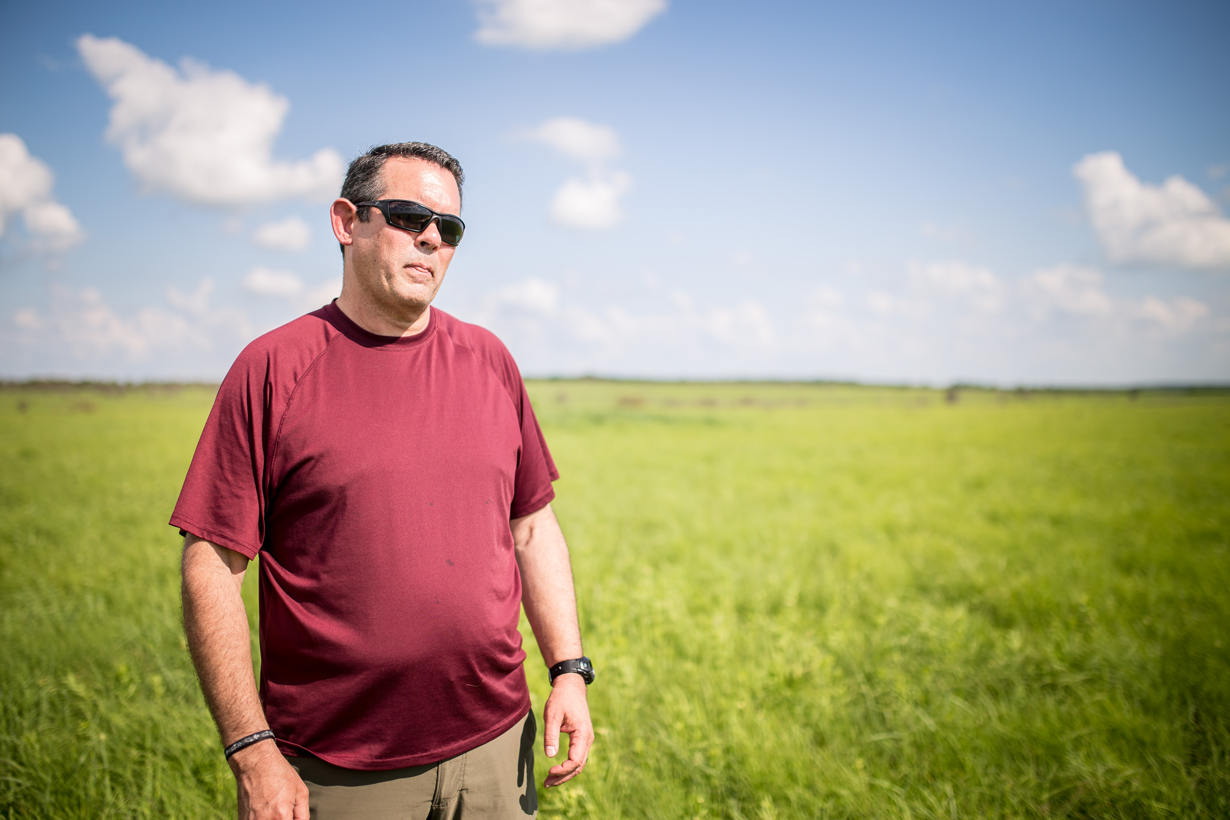 Daniel Howard conducting prairie mole cricket research at Joseph H. Williams Tallgrass Prairie Preserve.