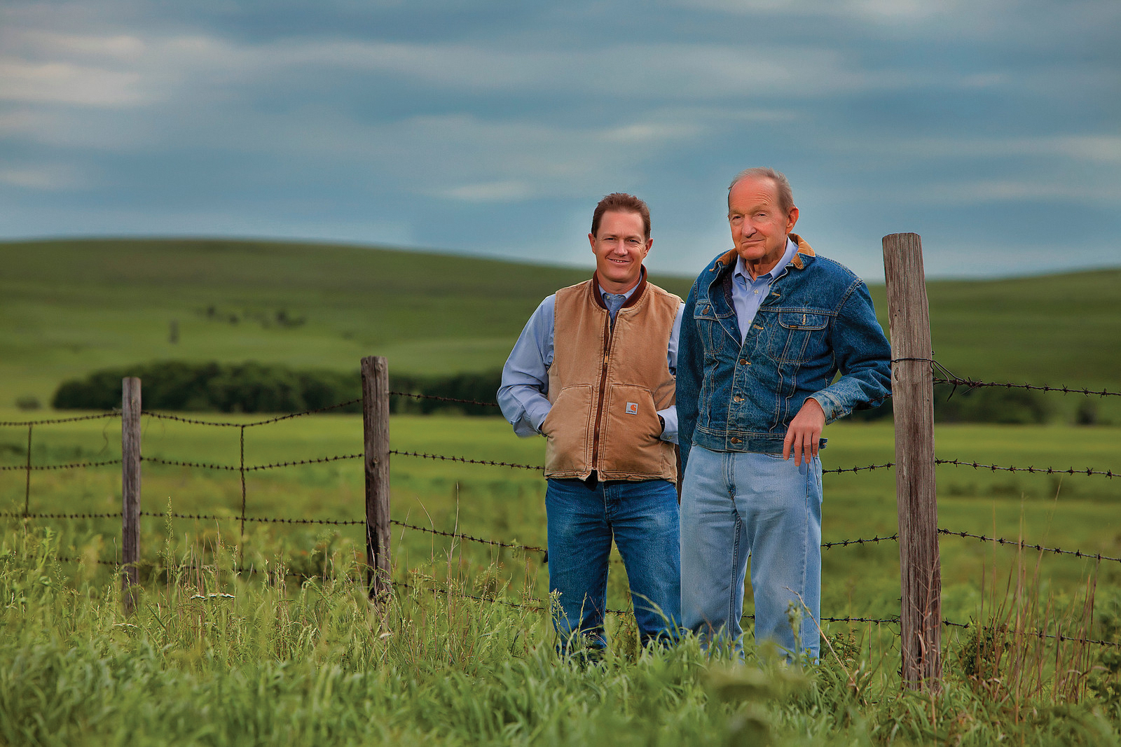 Ford and Frederick Drummond standing next to a fence.