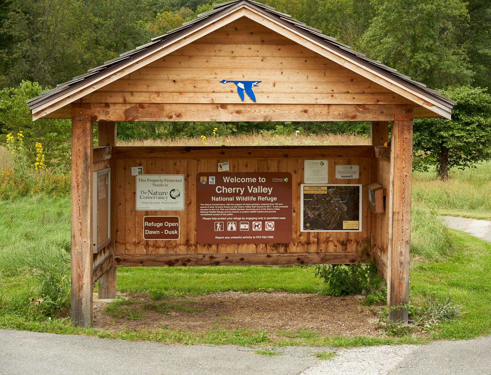 A wooden kiosk welcome visitors to Cherry Valley. 