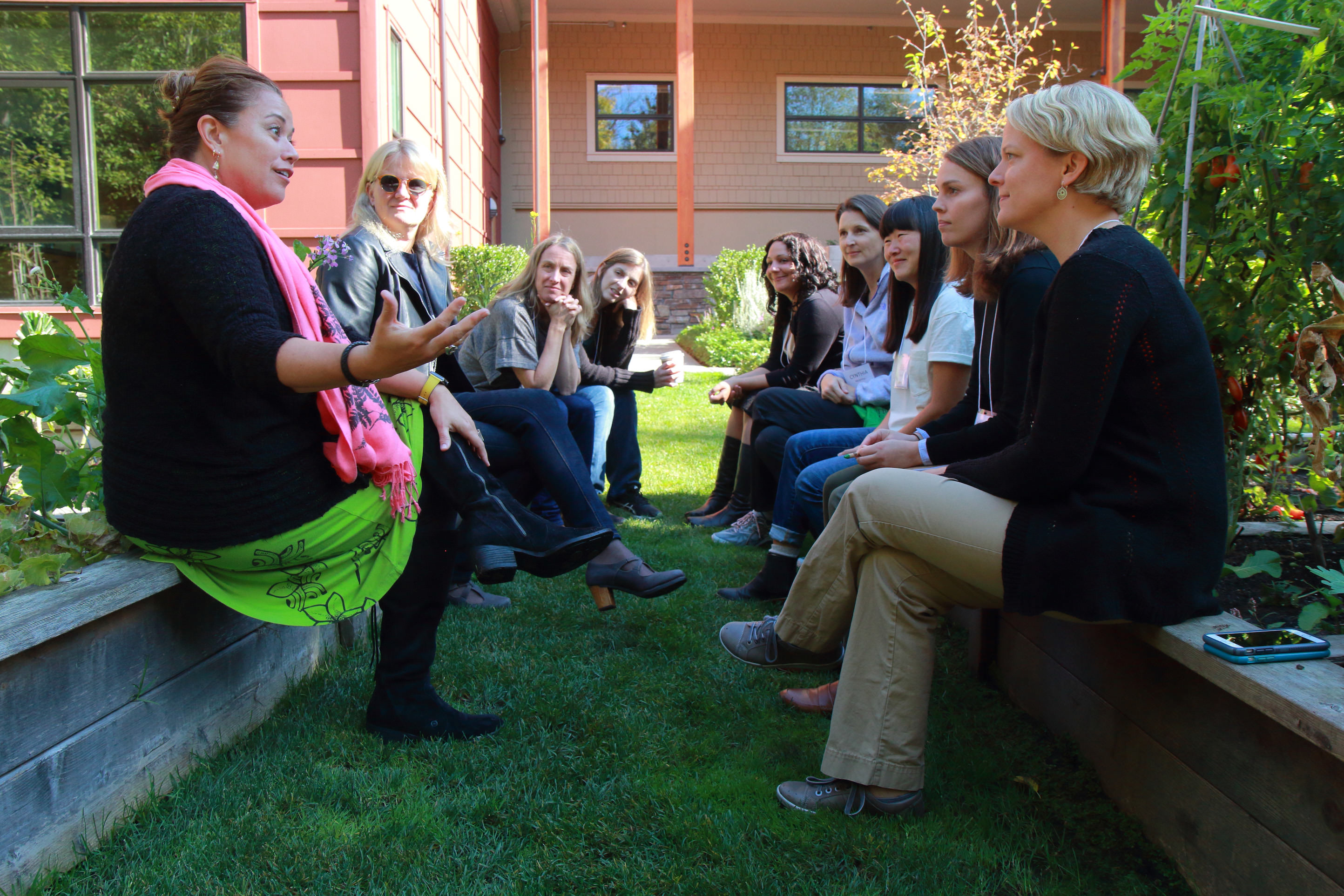 Women gather in courtyard garden.