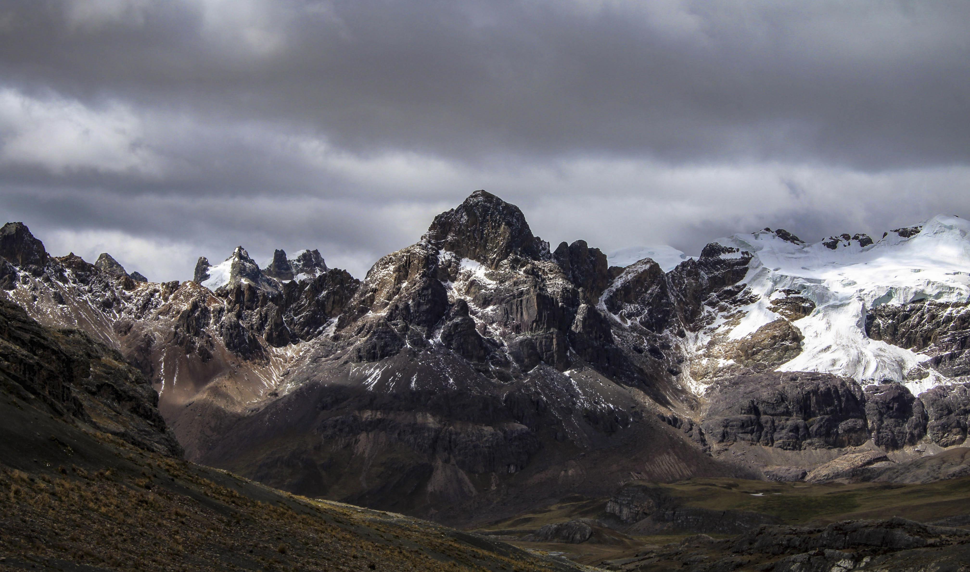 Mountain peaks in Peru with stormy clouds and snow.