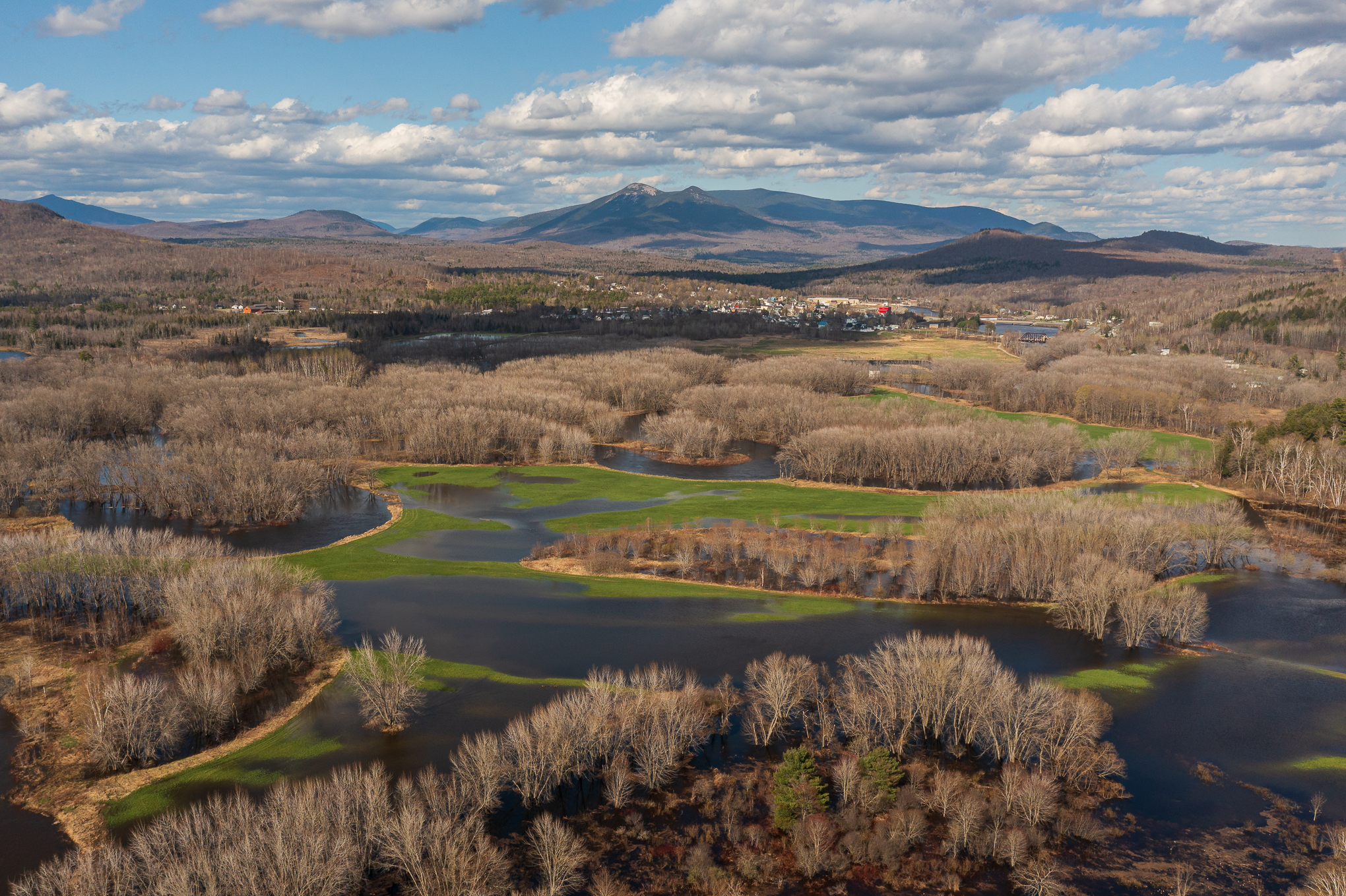 An aerial view of a river flooding over its banks.