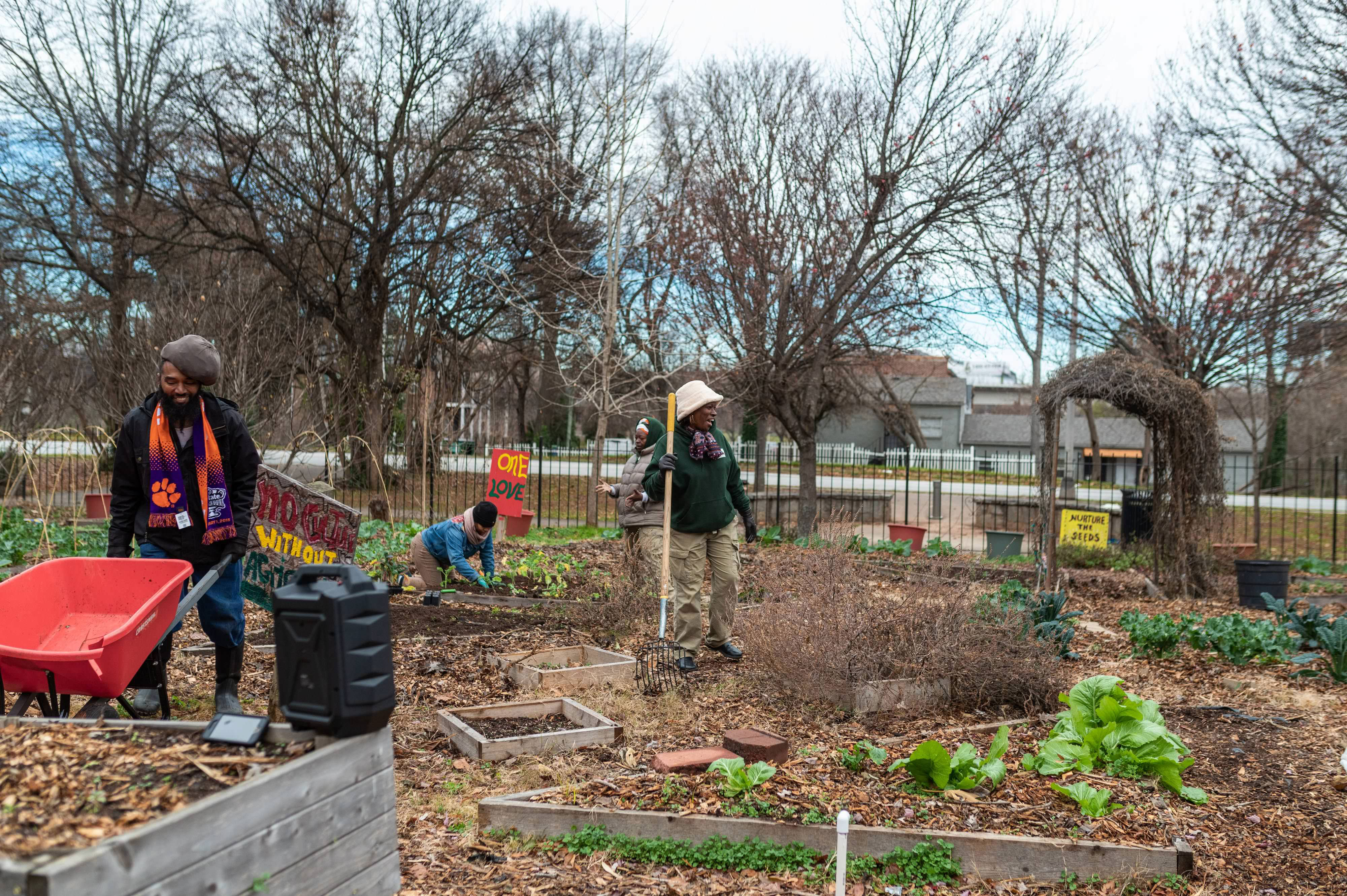 A group of people work together at a community garden.