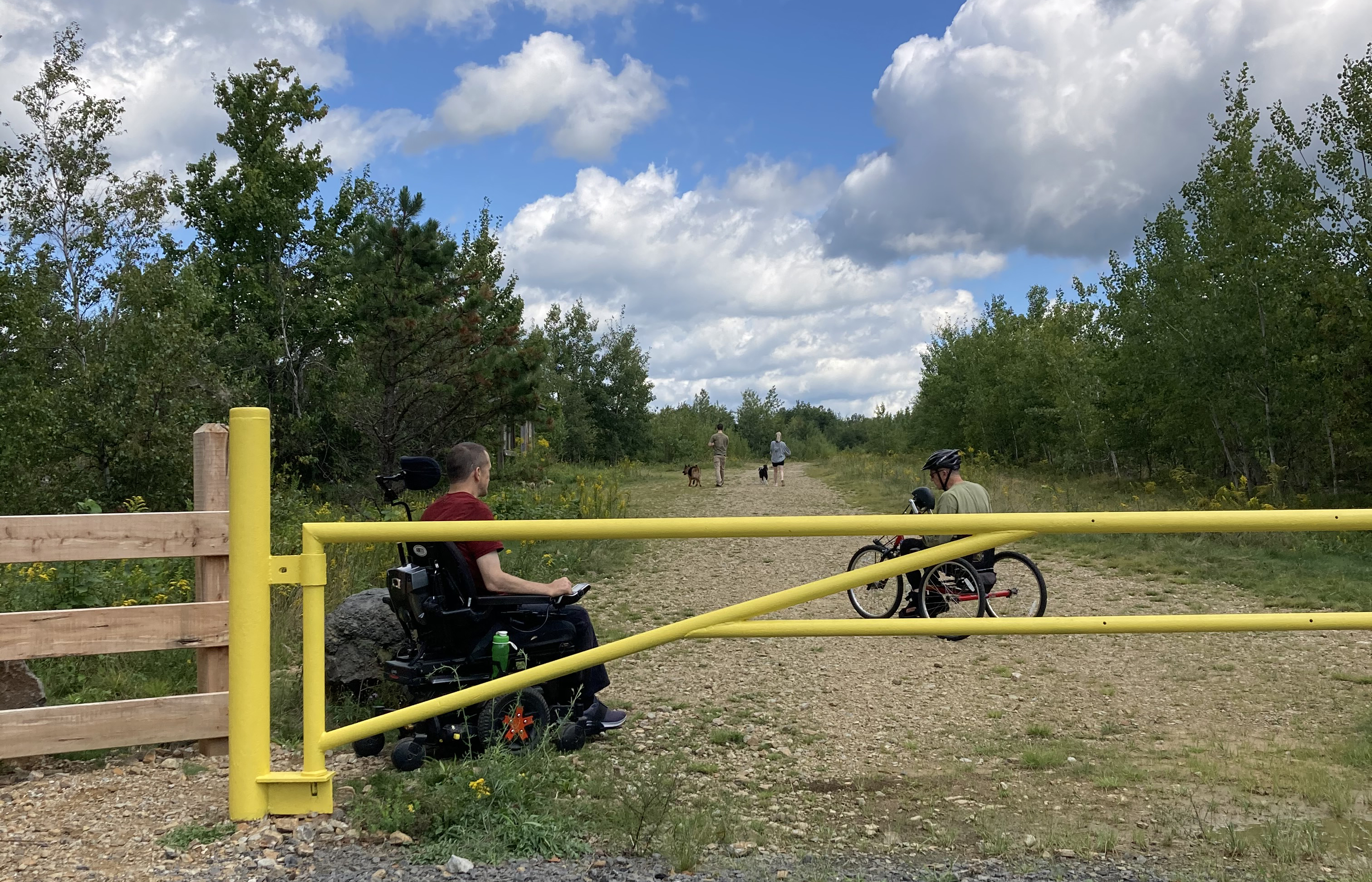 A man using a motorized wheelchair enters a preserve.