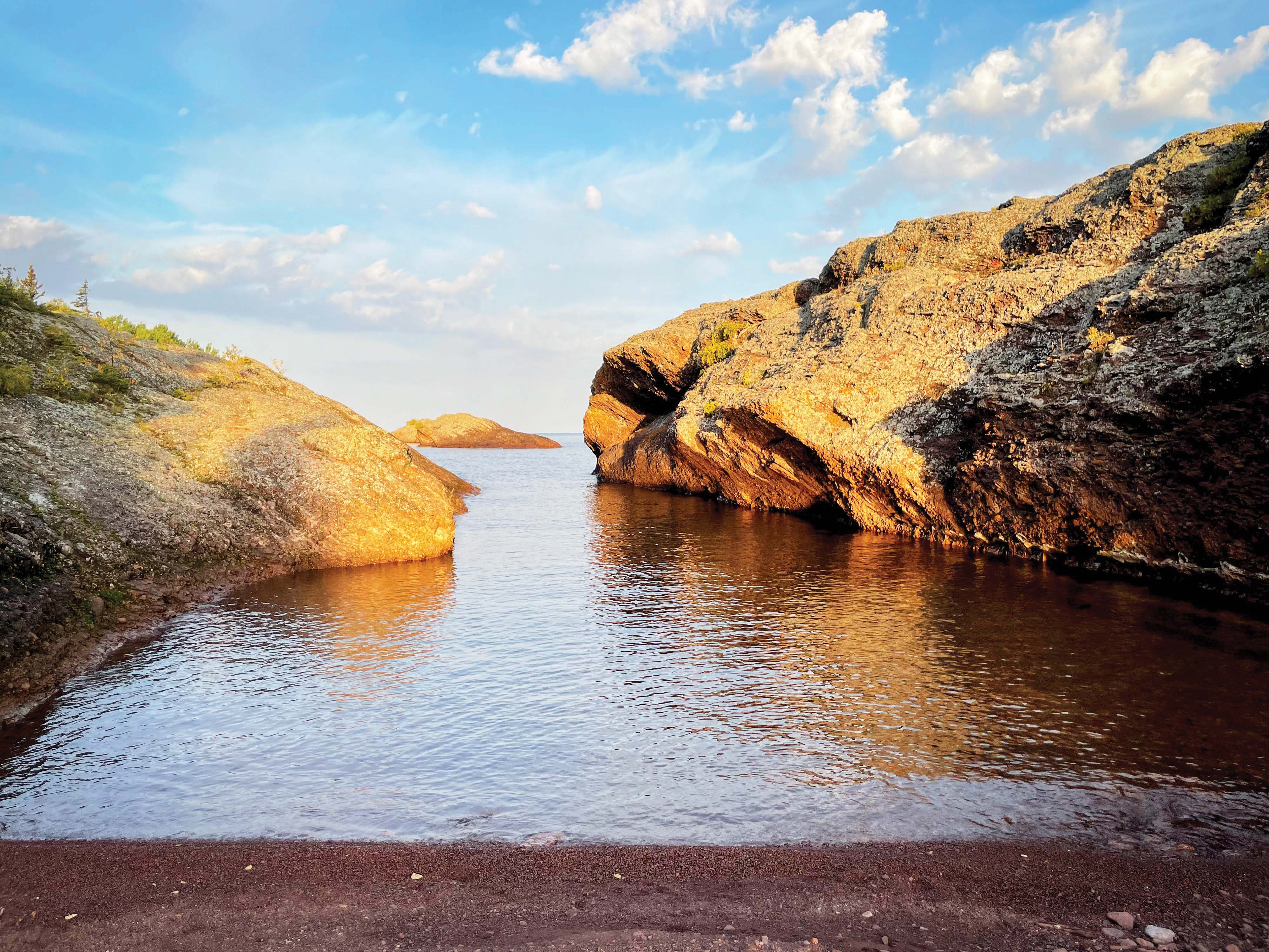 Sunrise hits the bay and bedrock at Mary Macdonald Preserve at Horseshoe Harbor.