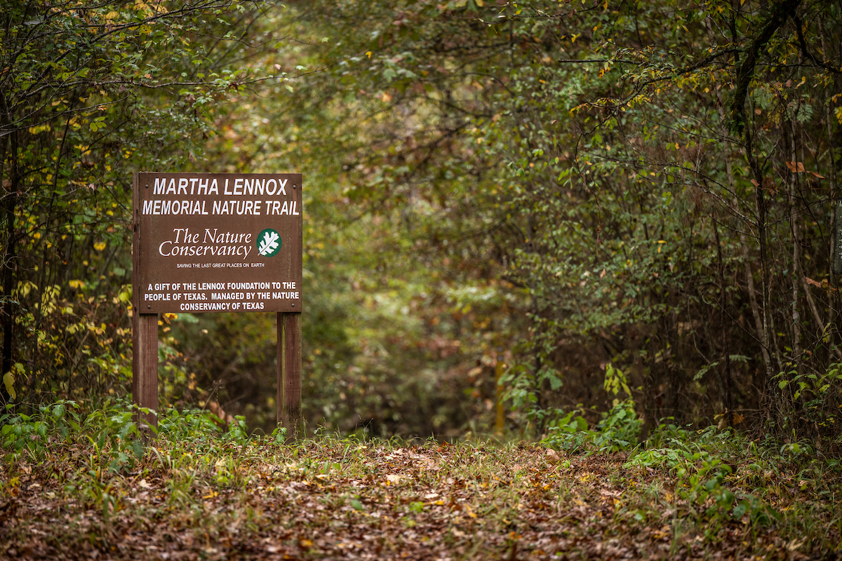A wooden sign reading Lennox Woods Preserve.