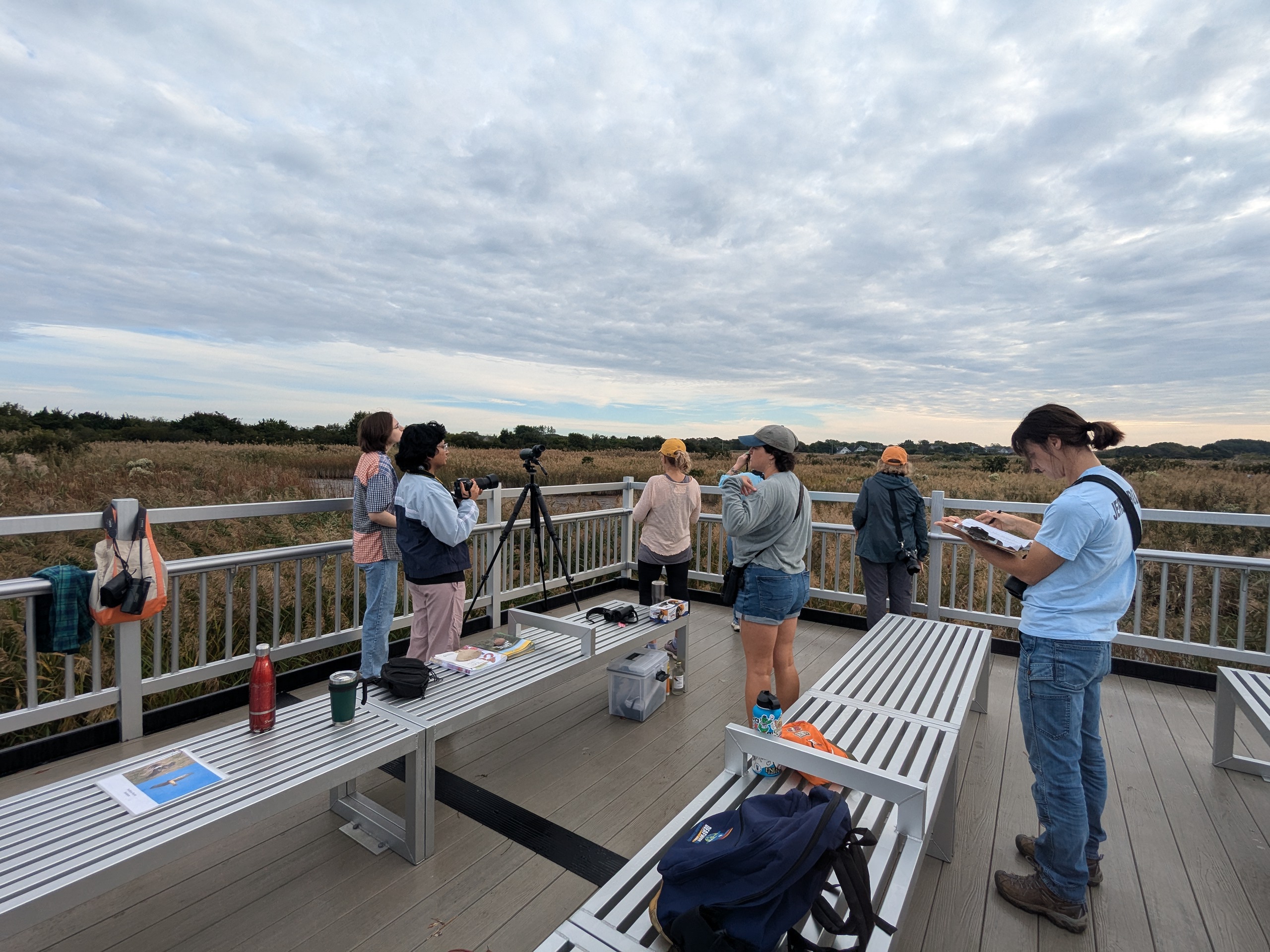 A group gathered on a boardwalk.