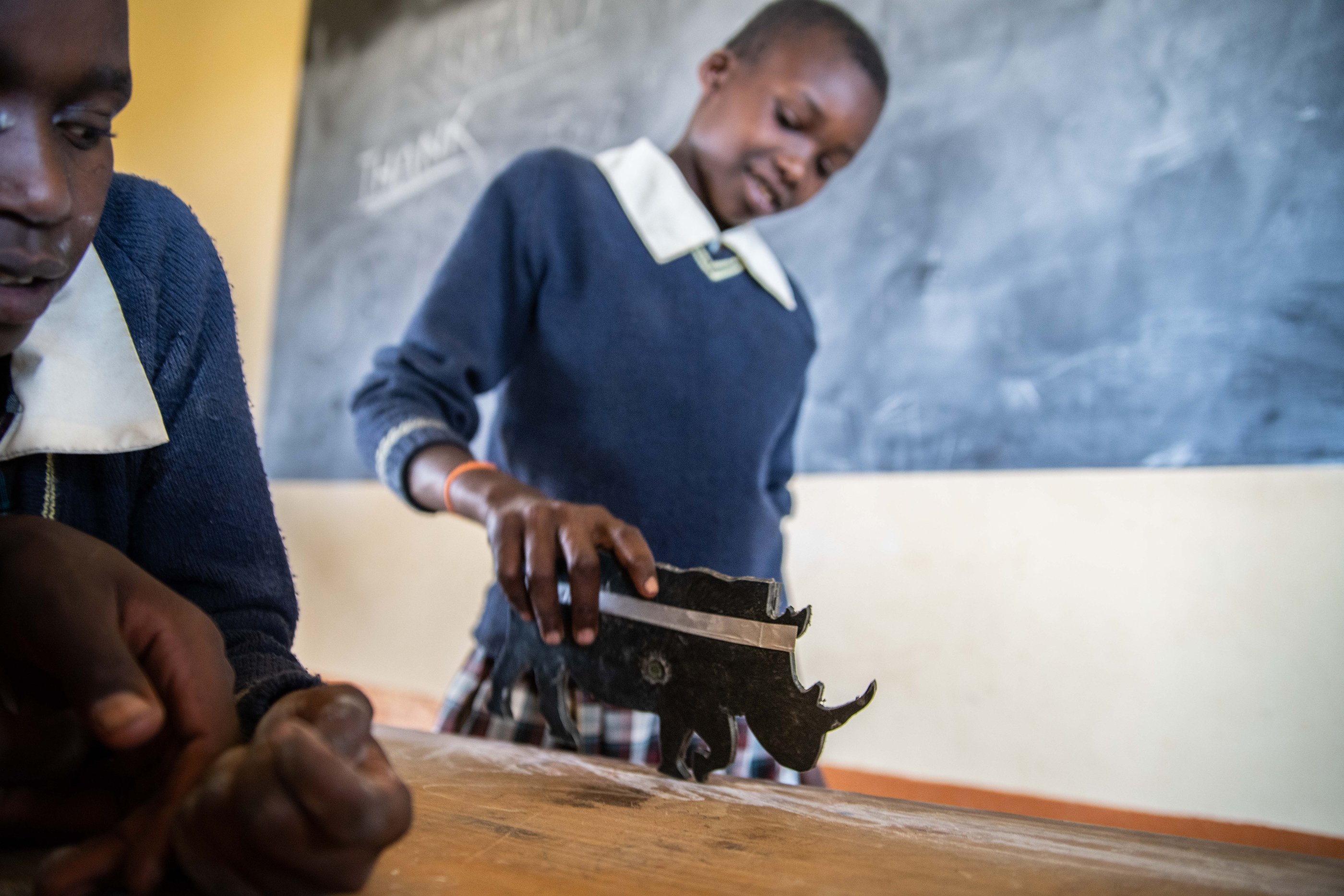 A student holding a rhino "flasher"