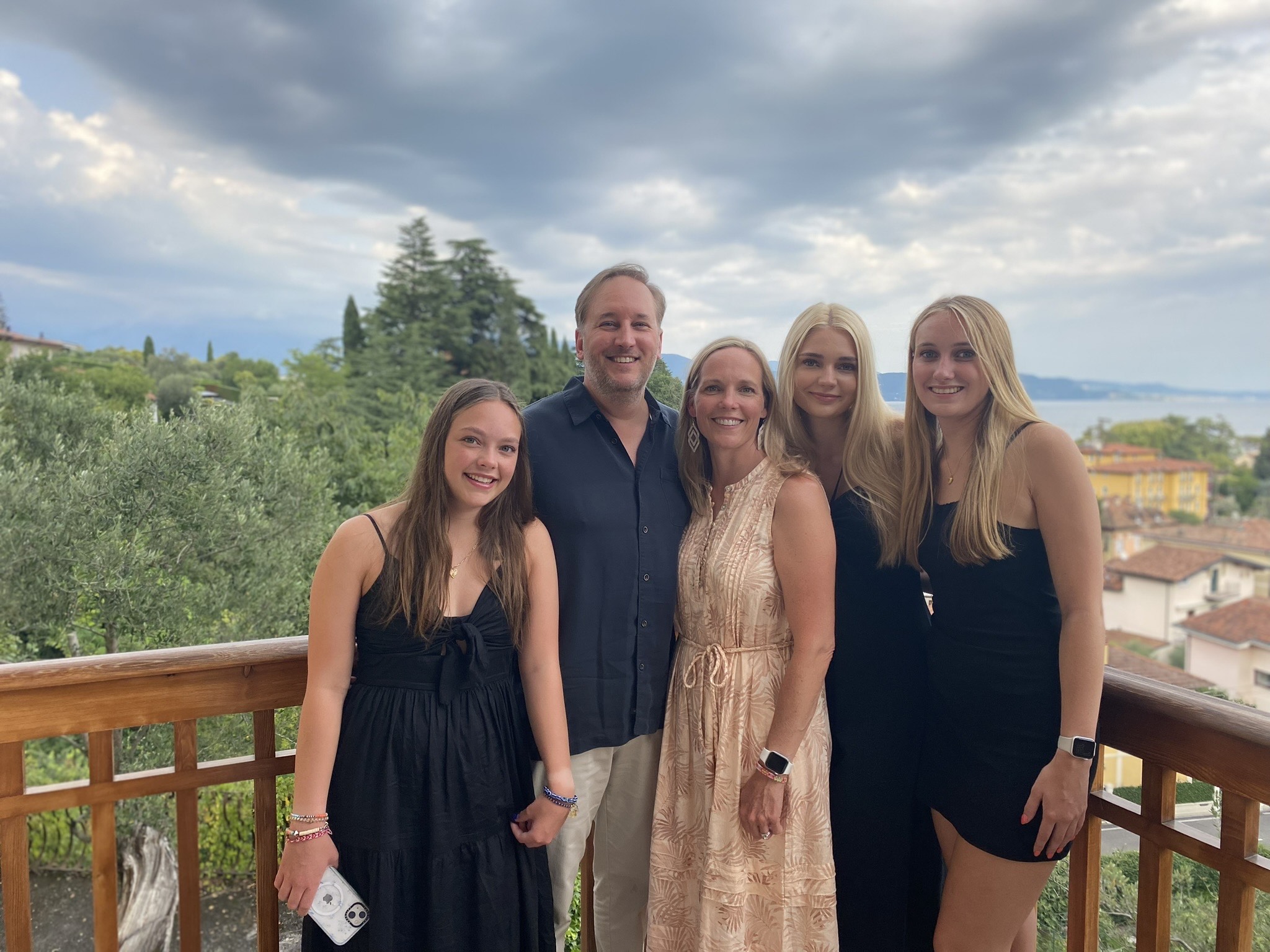 Five family members stand together smiling.