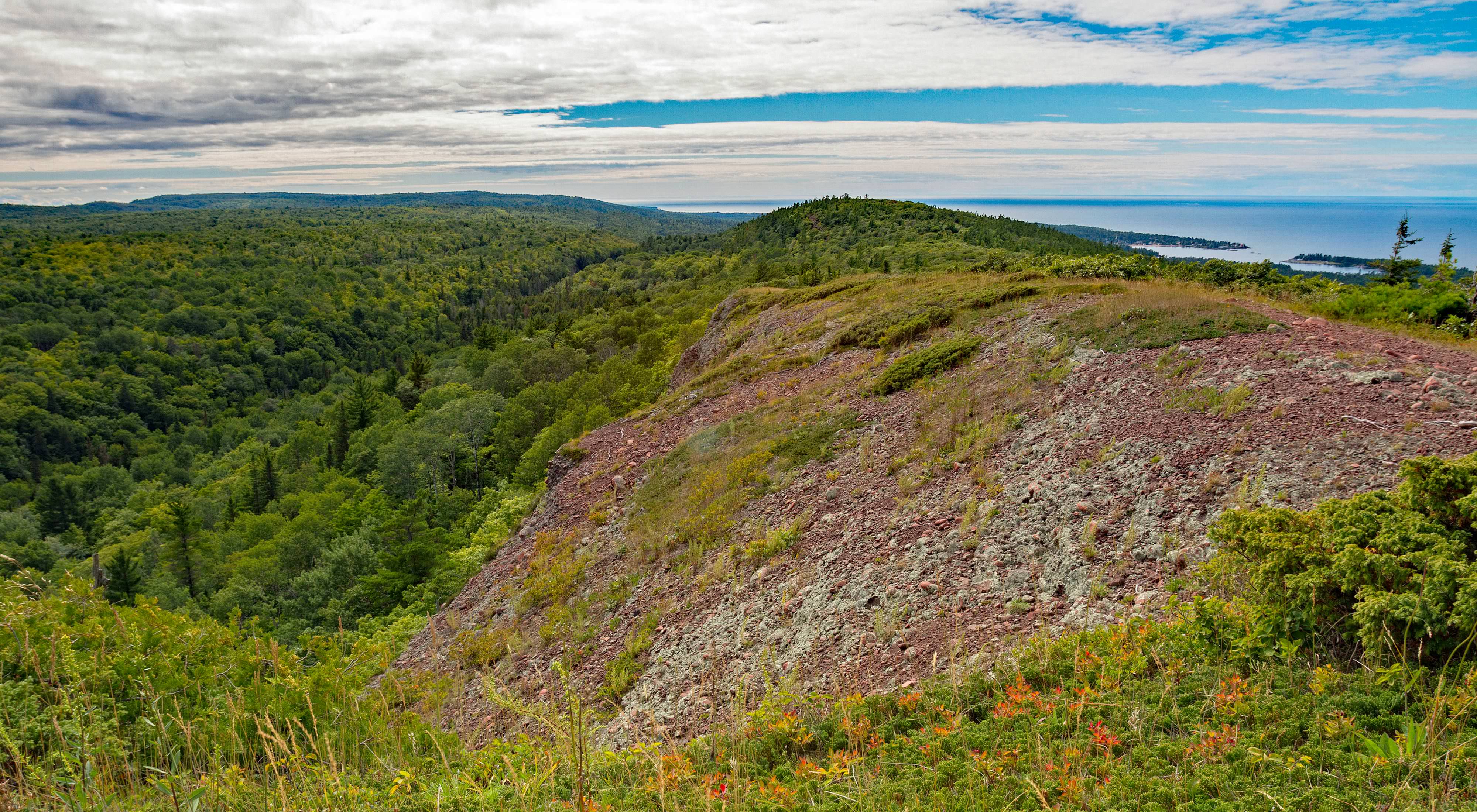 An aerial view features the top of the Mt. Baldy summit, overlooking Lake Superior. 