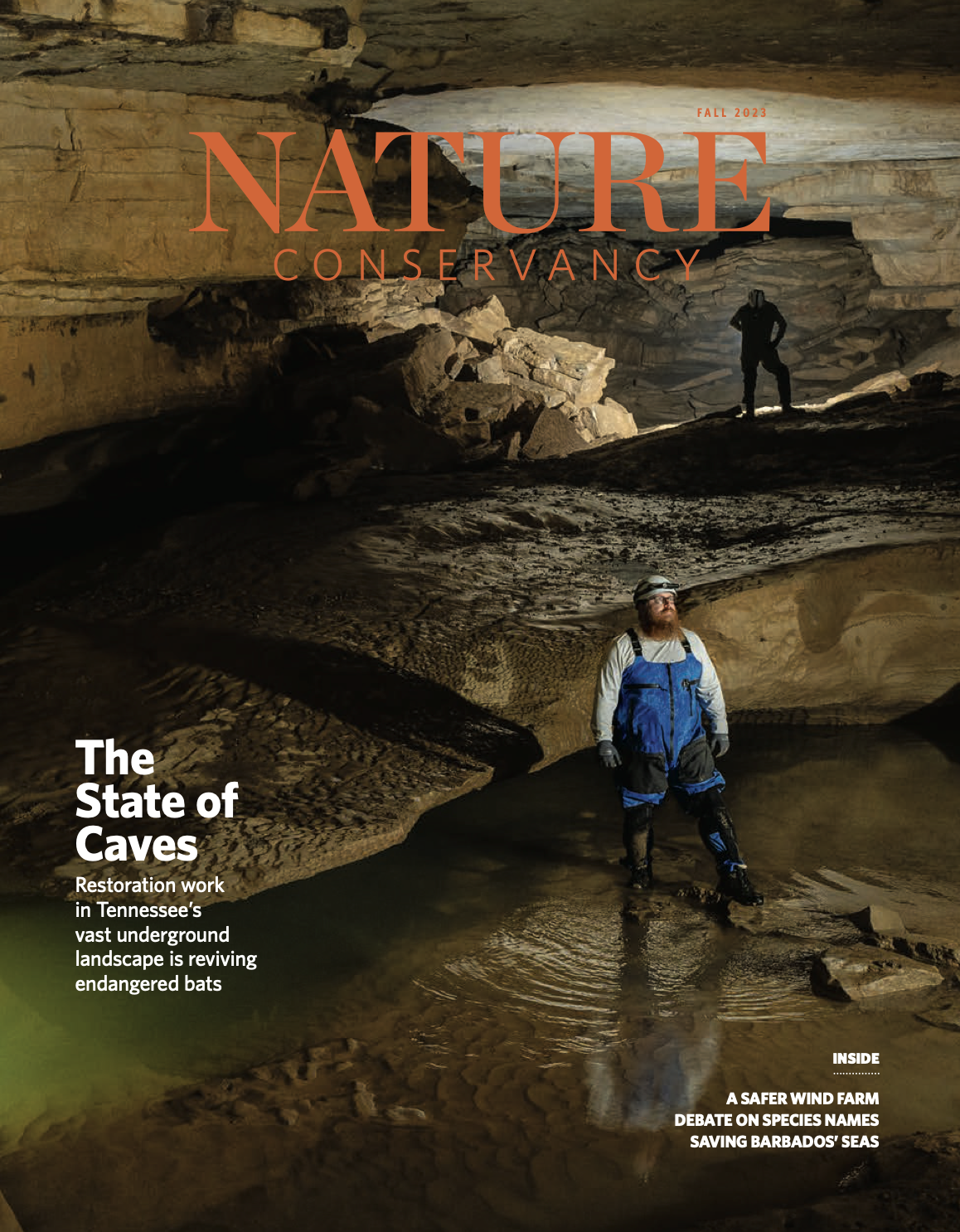 A magazine cover features a man standing in a cave wearing a helmet and safety glasses.
