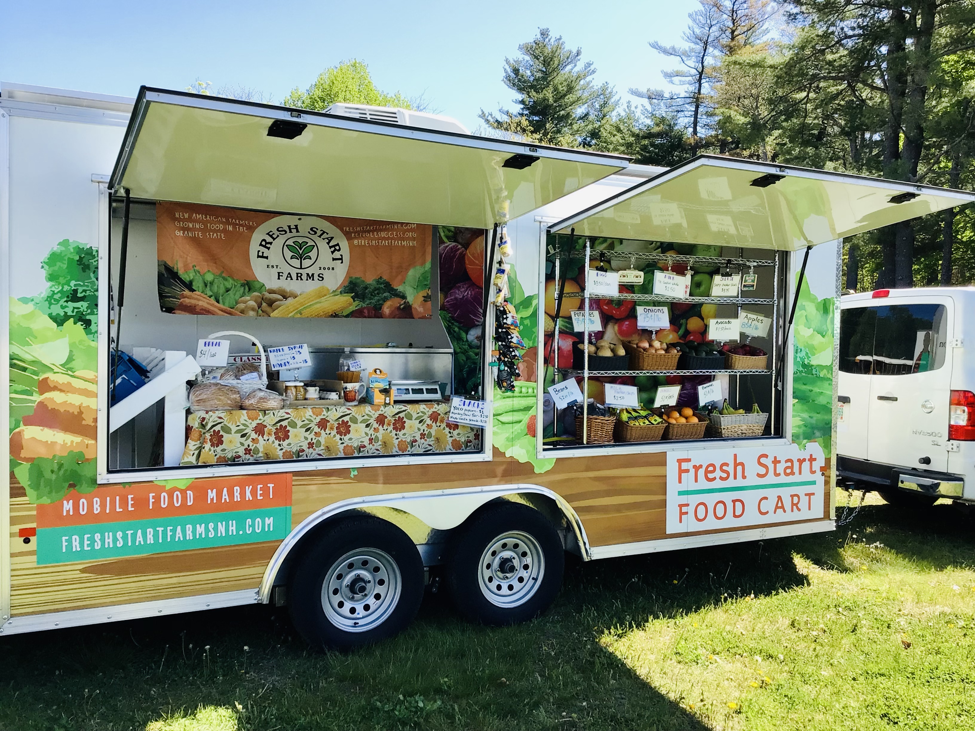 A mobile market cart with fresh fruits and vegetables.