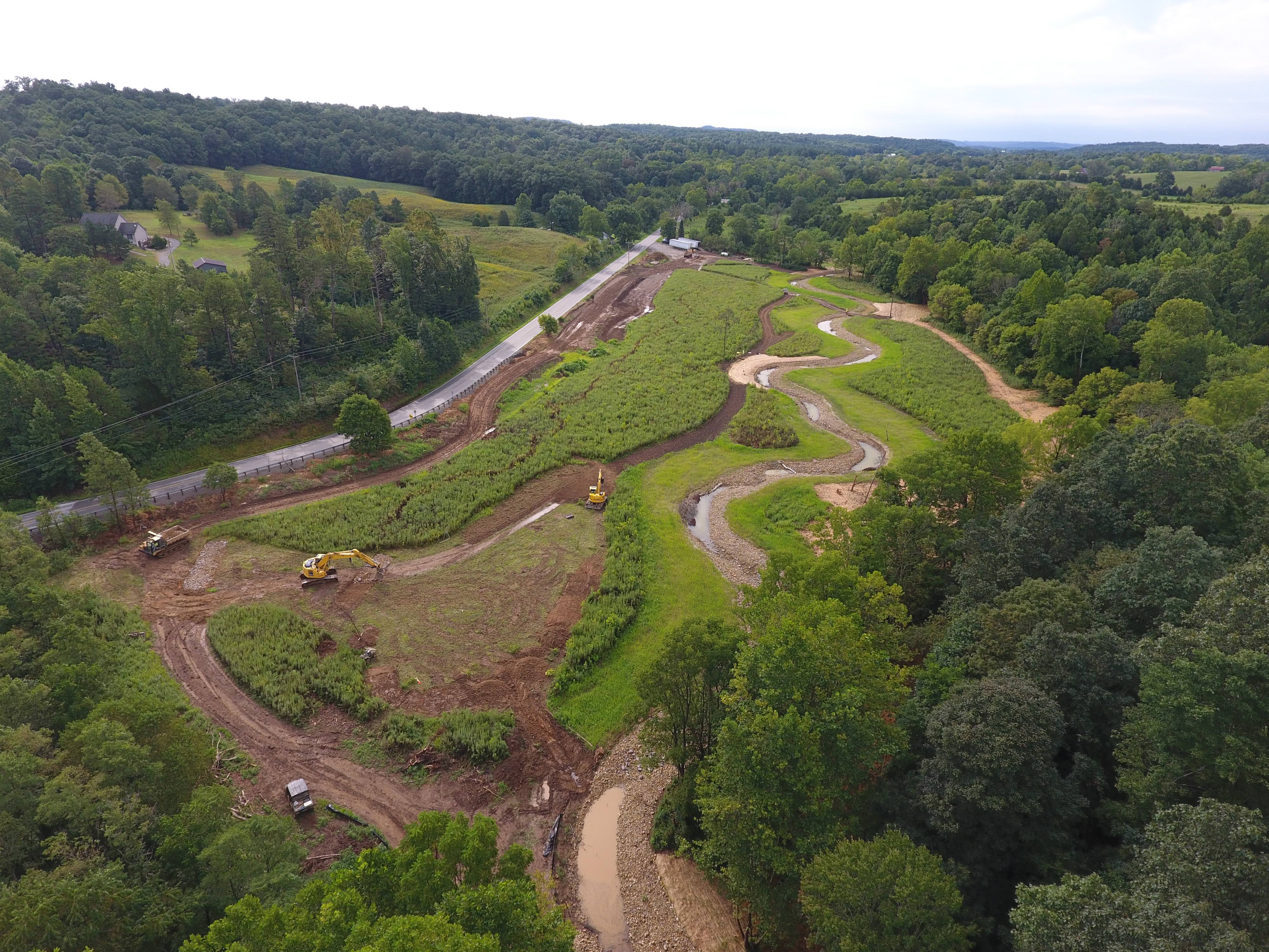 Looking down on a winding stream in summer.