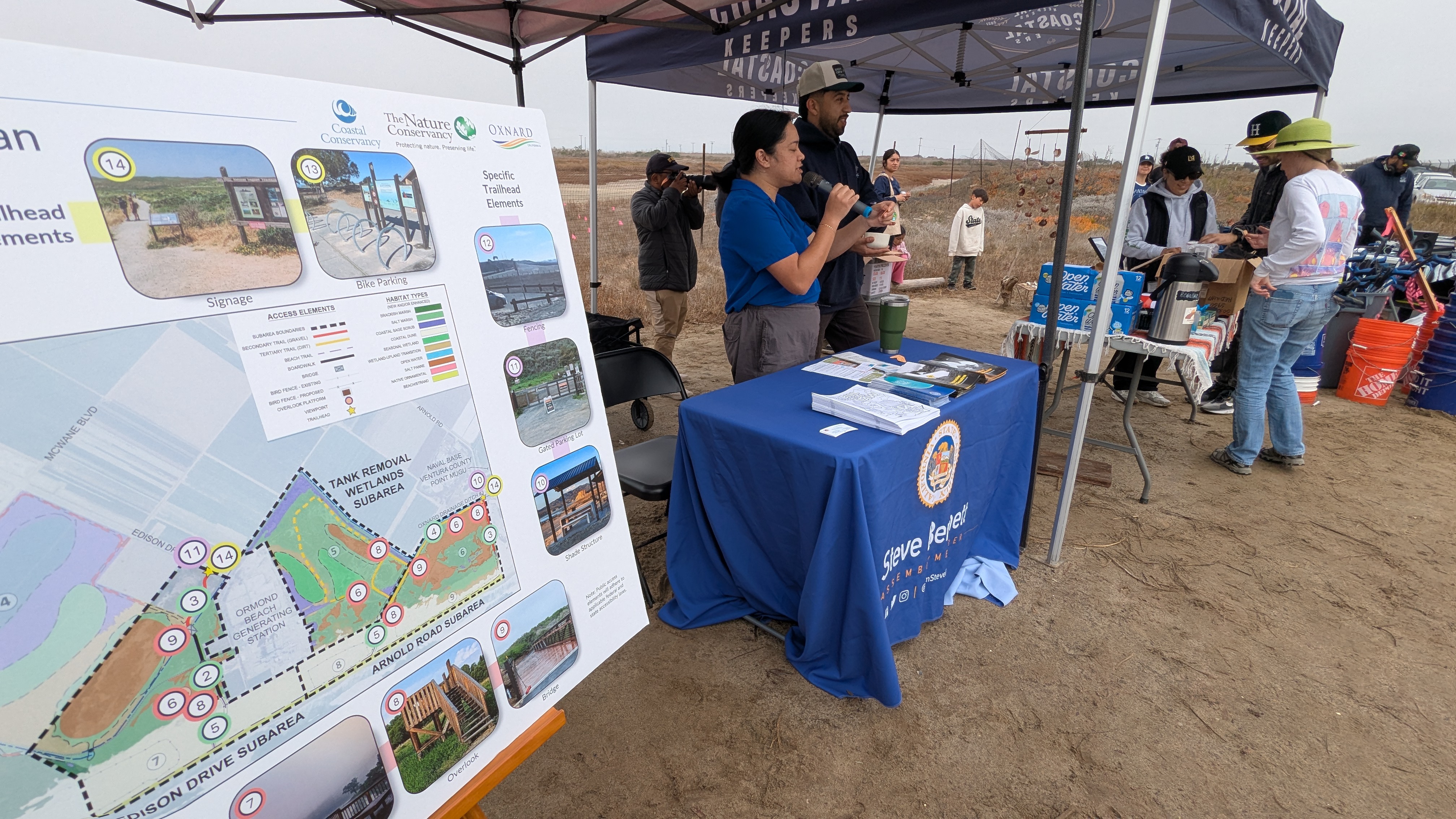 A booth on Ormond Beach with a map on the restoration of the site.