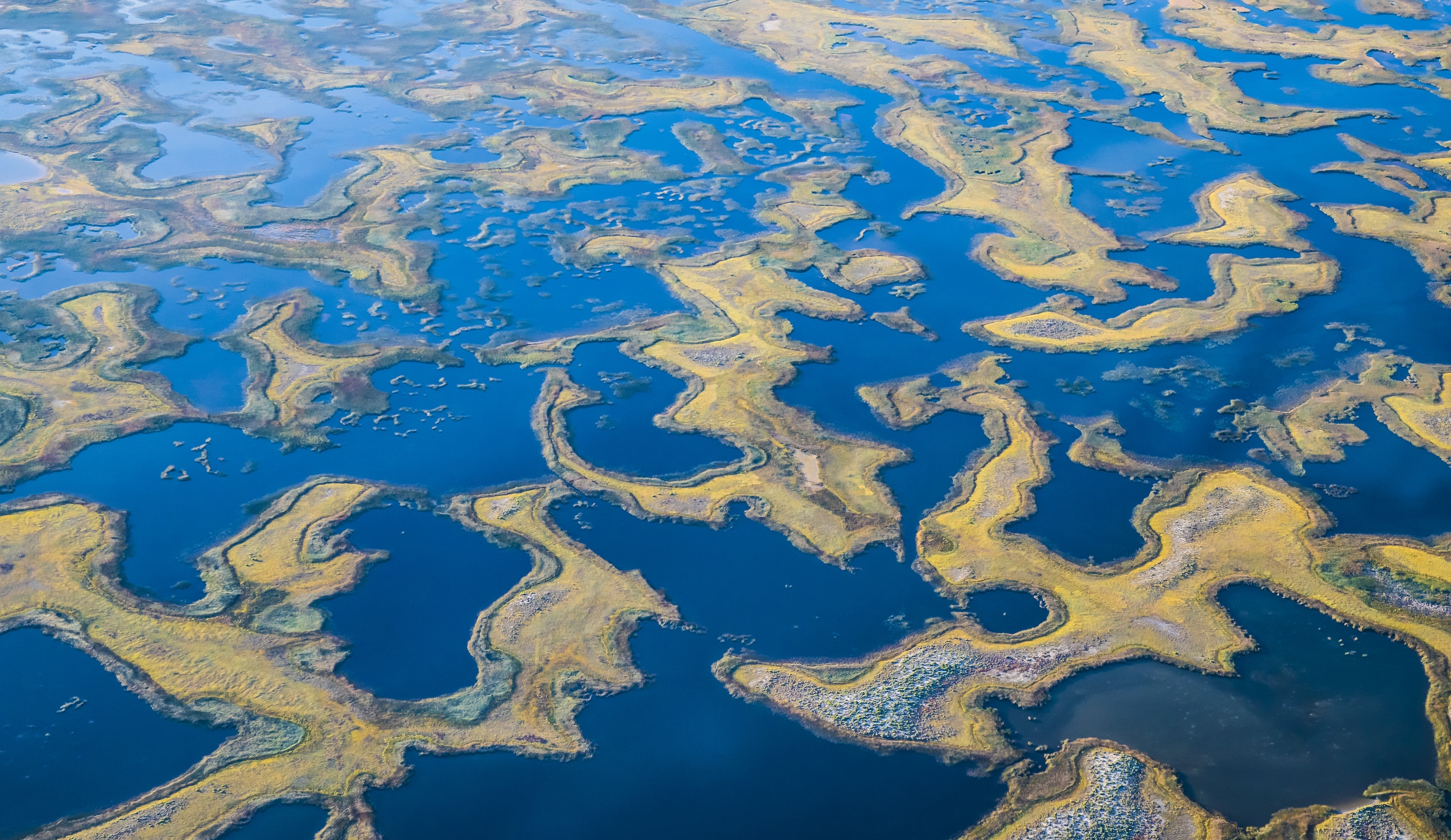 An aerial image of groundwater sitting amongst rocks.