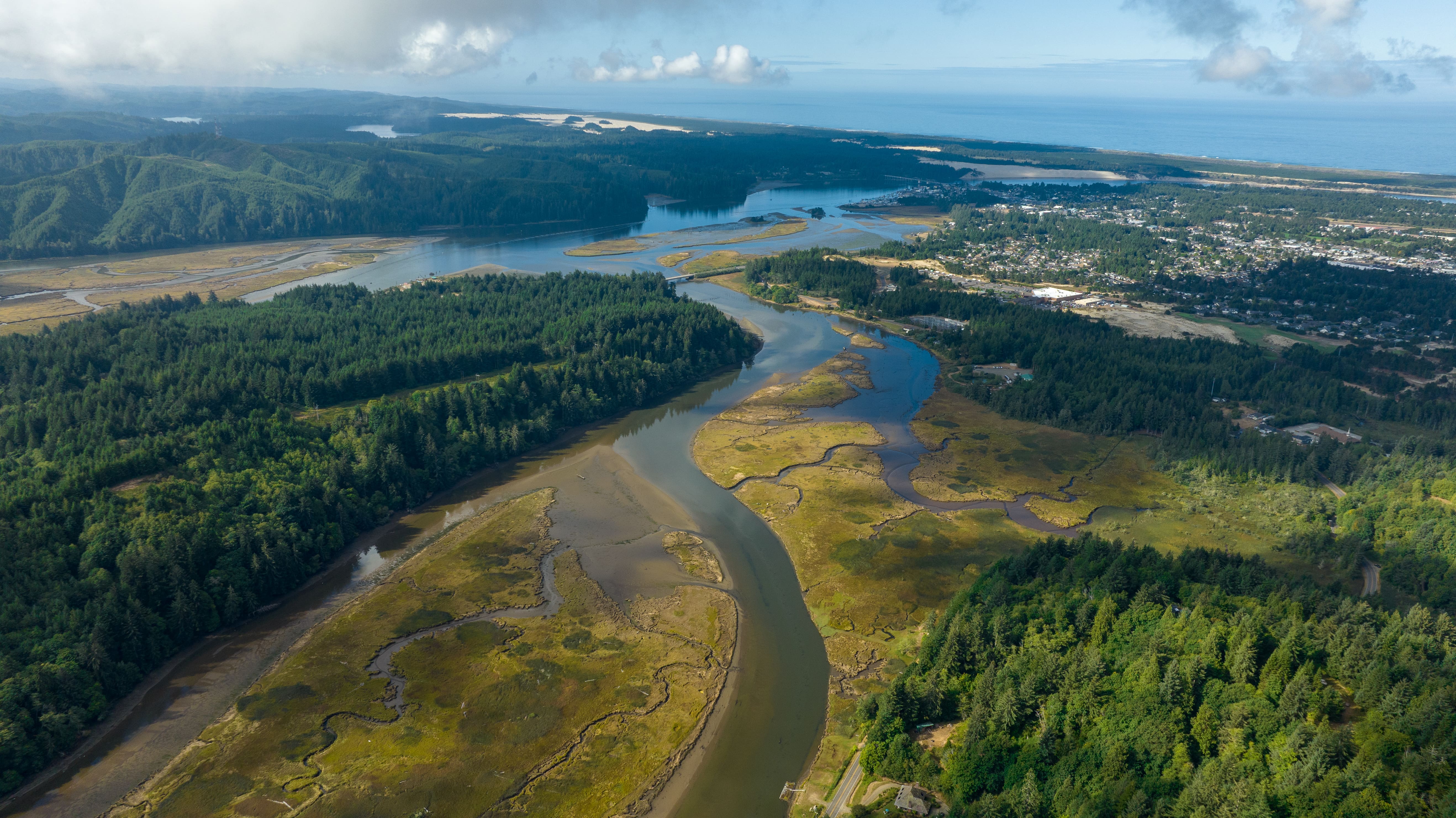An aerial photograph features a river flowing into an estuary.
