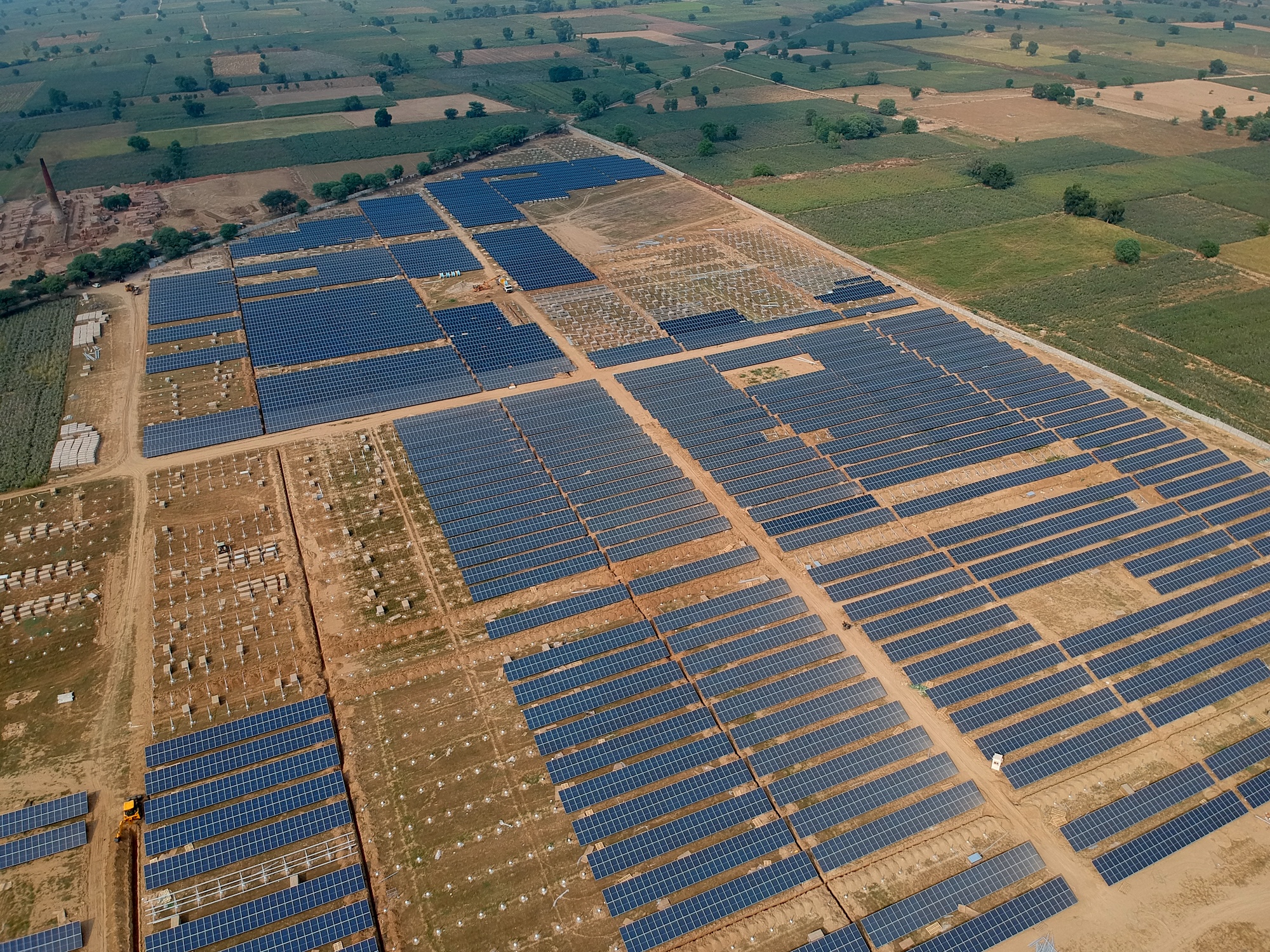 An aerial image of a massive solar farm -- grids of solar panels in a field.