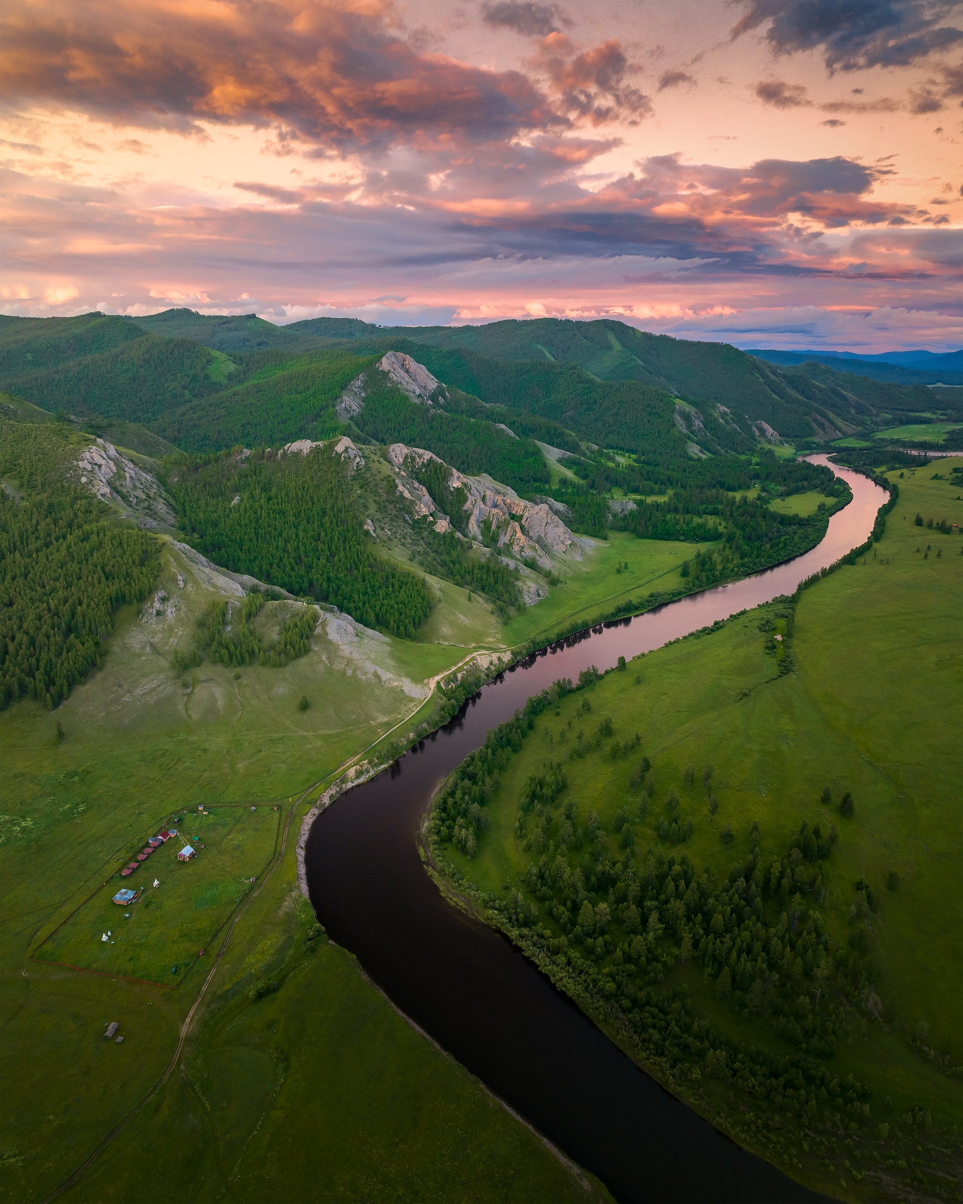 Aerial view of river running through mountains.