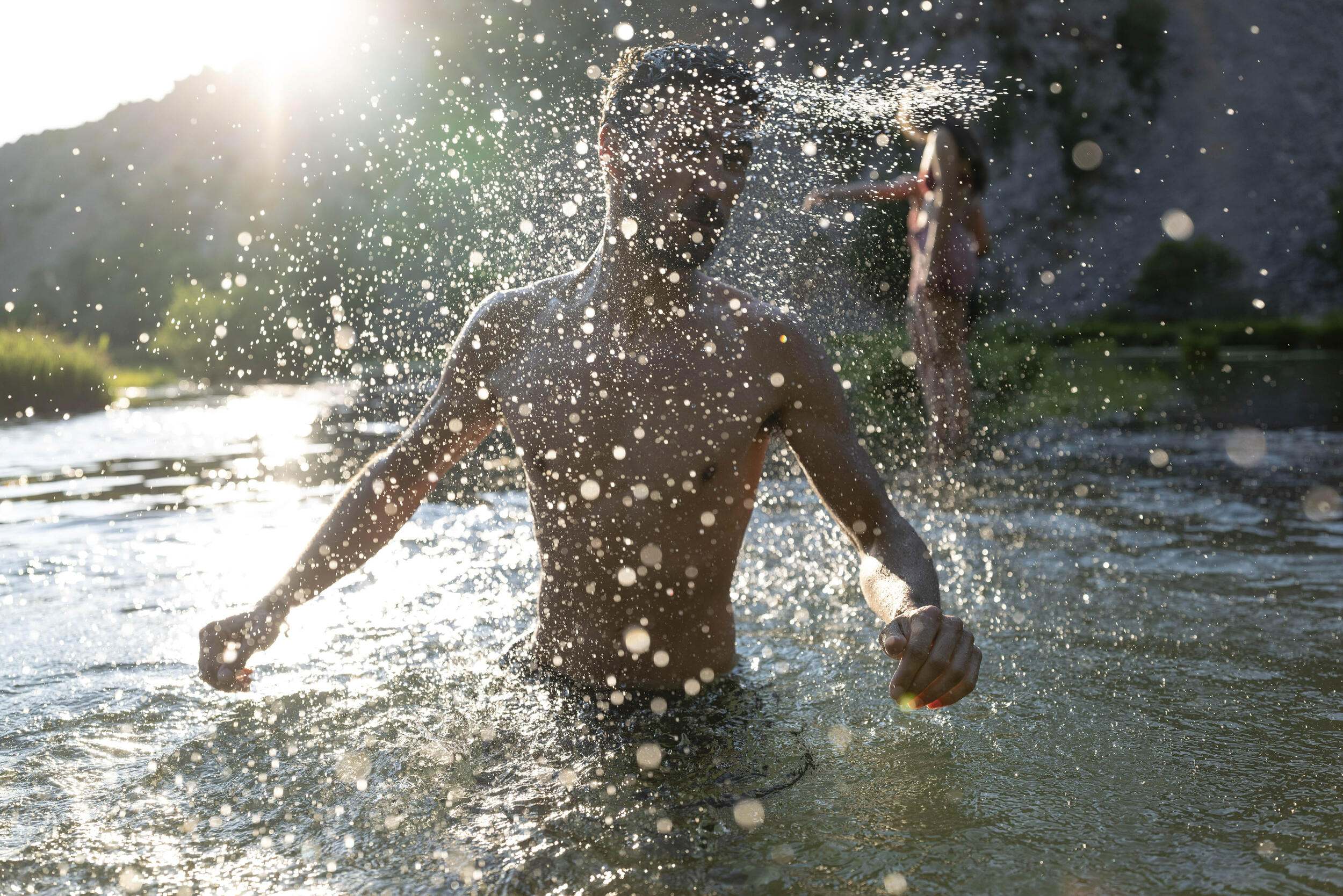 A hiker splashes through the Krupa River in Dalmatia, Croatia.